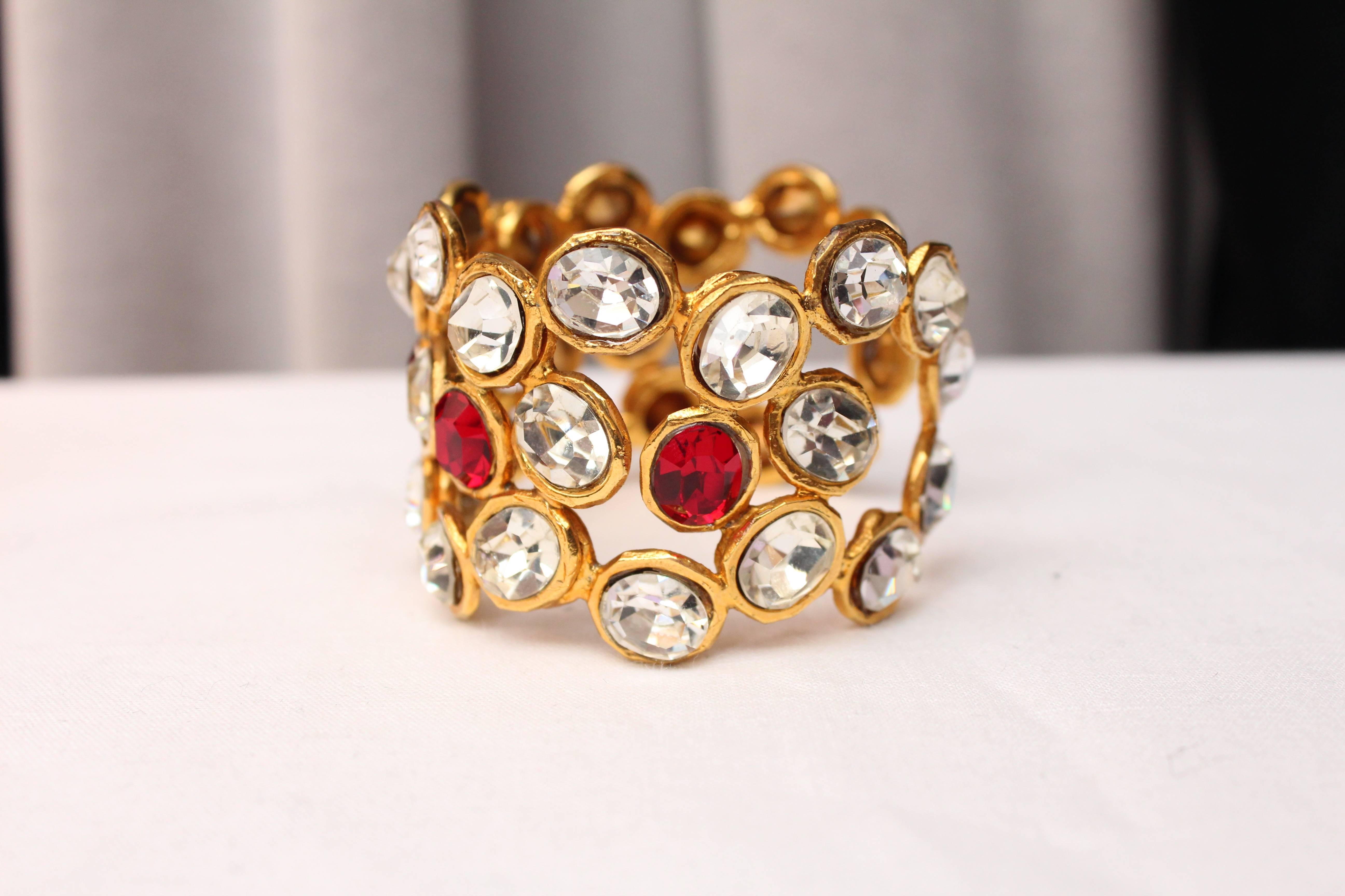 CHANEL (Made in France) Openwork gilt metal bracelet cuff paved with red and white large oval crystals. 

Collection 2 9

Very good condition.

Measurements:
Wrist size: 18 cm
Open space: 3 cm