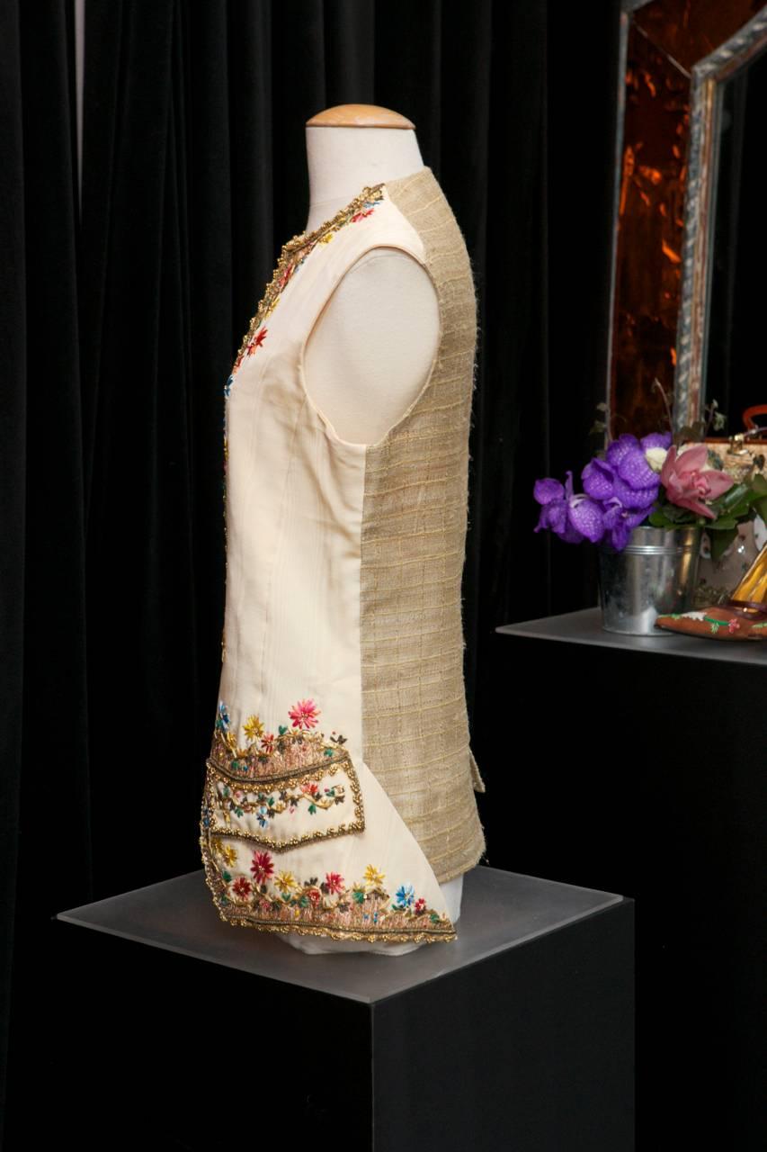 CHRISTIAN LACROIX PARIS Beautiful waistcoat in ecru satin, embroidered with pink, blue, green, yellow and turquoise raffia in a floral motif. 

The raffia is completed with lame threads, and adorned with gilded sequins and chiselled metal beads.