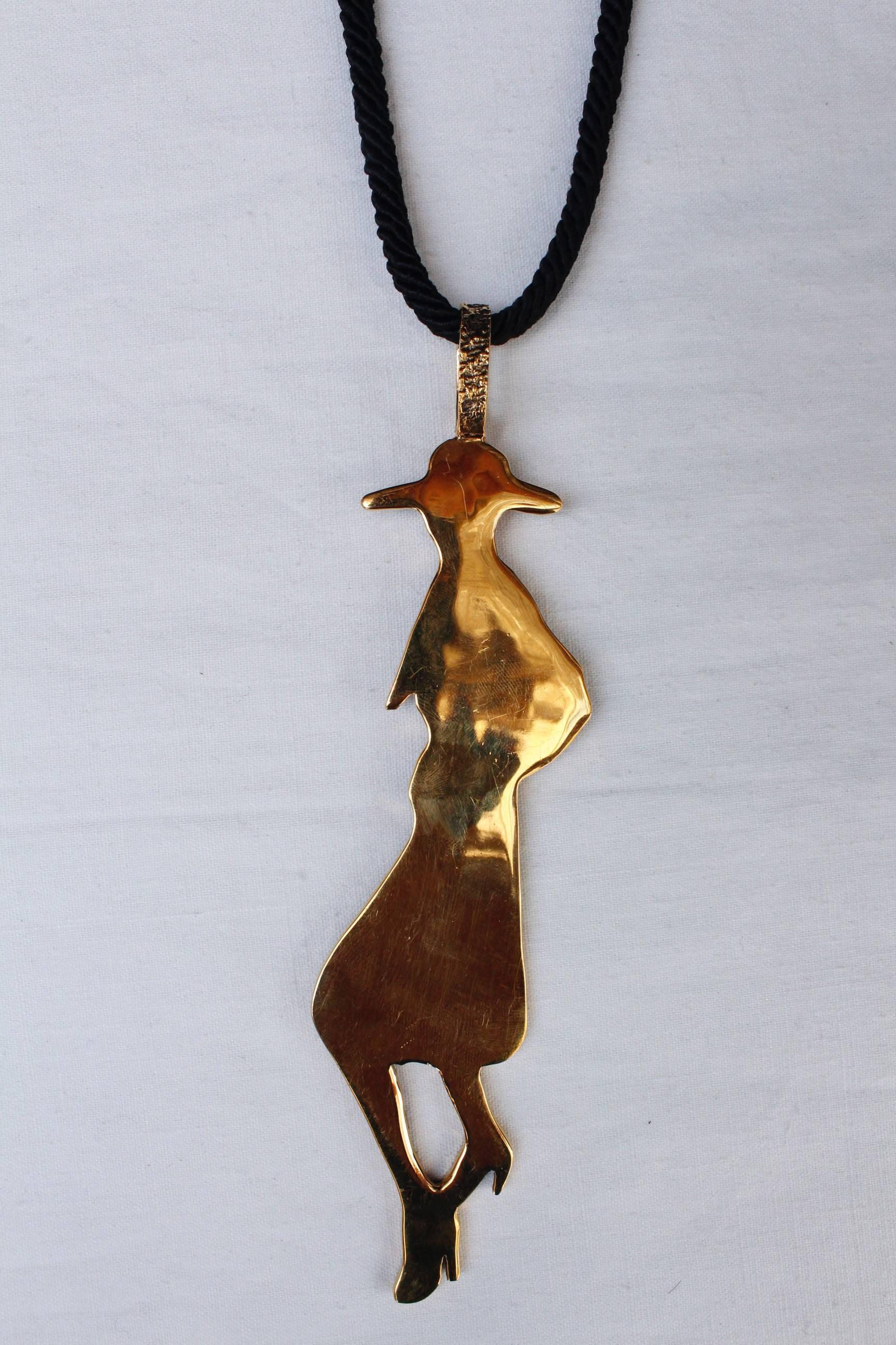 Yves Saint Laurent long silhouette pendant necklace composed of gilded metal and In Excellent Condition In Paris, FR