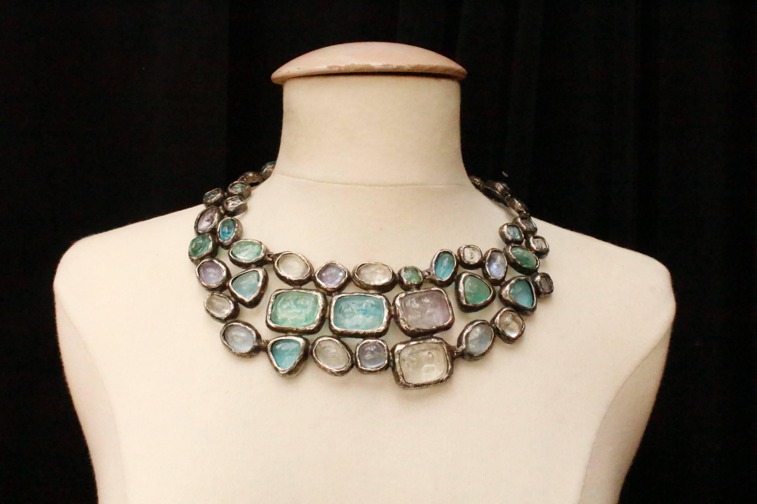 CHANEL (Made in France) Unique blackened silver plated breastplate necklace, paved with cabochons in pastel blue, green, purple and transparent glass paste. The necklace is articulated in the neck , and the center part is rigid. Hook and eye