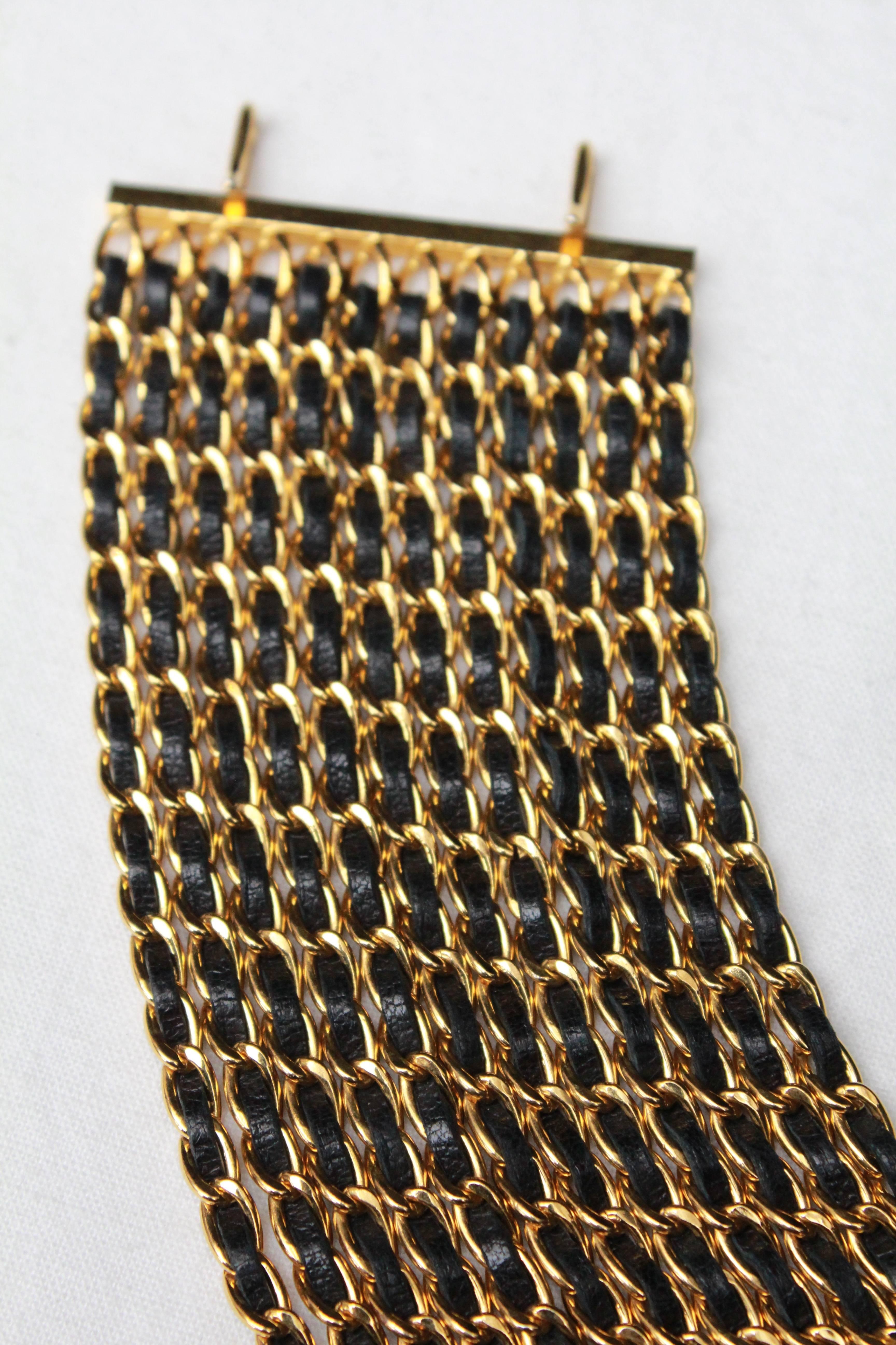 Chanel wide bracelet composed of gilded metal chains with black leather, 1990s  1