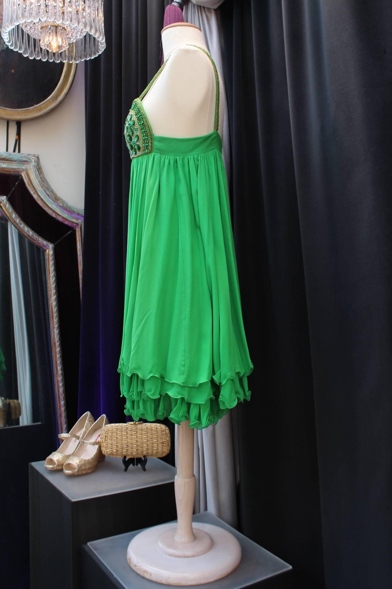 SERGE LEPAGE HAUTE COUTURE (Paris) Short skater dress with shoulder straps, green silk chiffon embroidered with seed beads and green and bronze sequins at bust.

Green silk lining.

Back zip closure.

Circa 1980.

Size 36 (US 4 S).

Length 92 cm (36