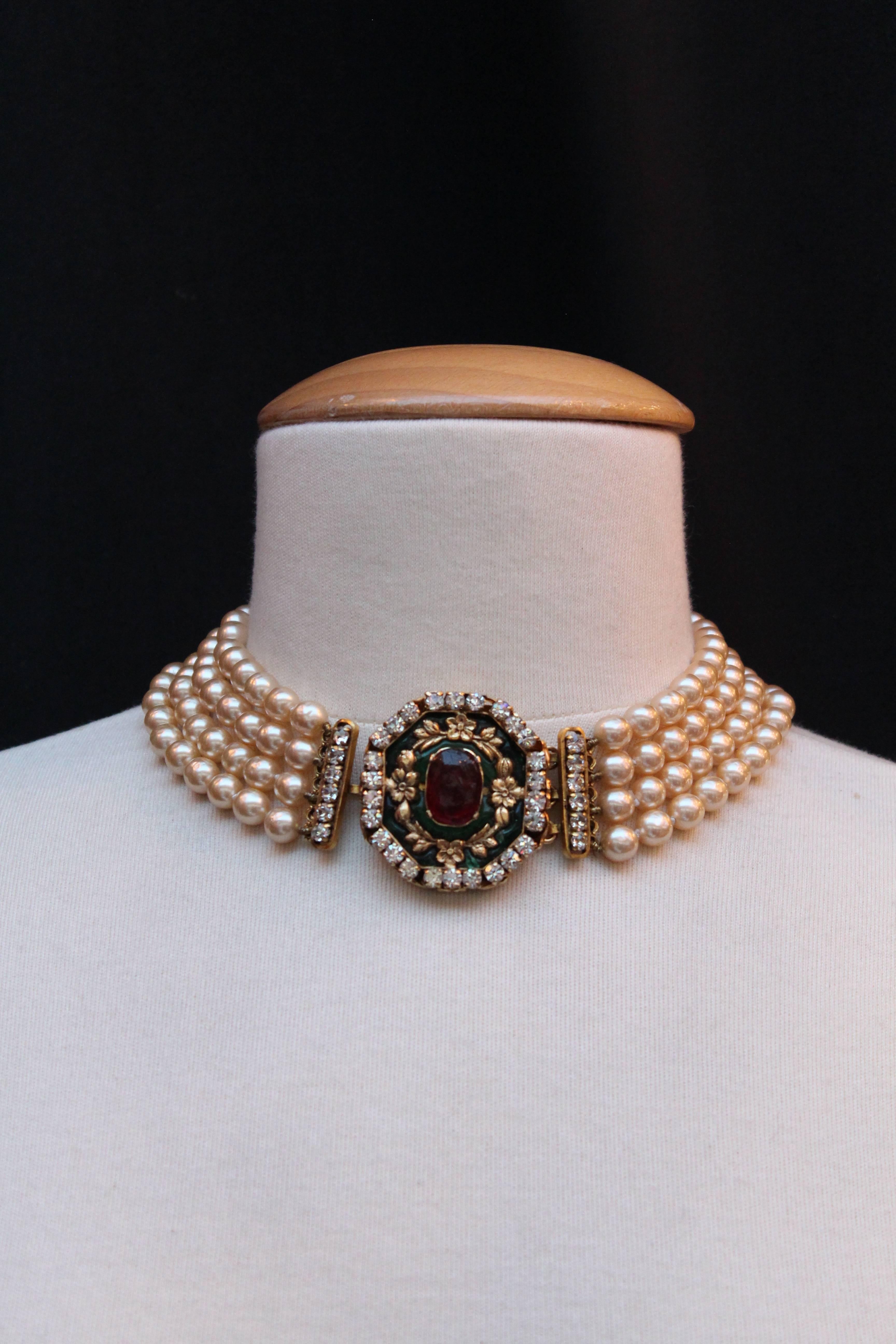 CHANEL (Made in France) Romantic-style choker created by Gripoix workshop for Chanel. It is comprised of four strands of knot-mounted pearly beads and a magnificent jewel clasp representing a gilded metal medallion.  A center  ruby glass paste