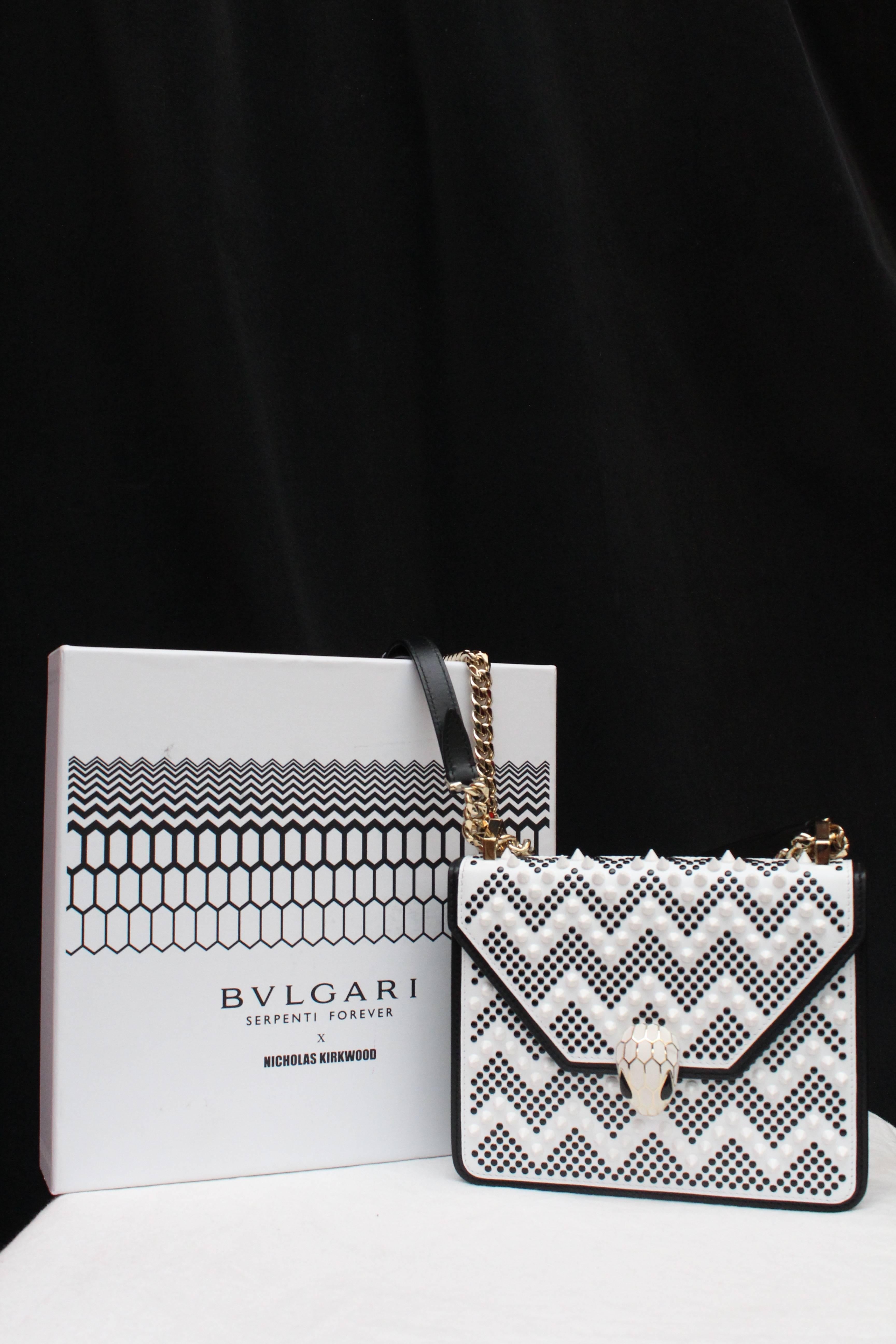 BULGARI (Made in Italy) Bag model Serpenti Forever Nicholas Kirkwood, made of black and white calf skin decorated with a studded tonal chevron pattern. The Serpenti clasp is composed of brass and white enamel with onyx eyes. Gilded metal curb chain