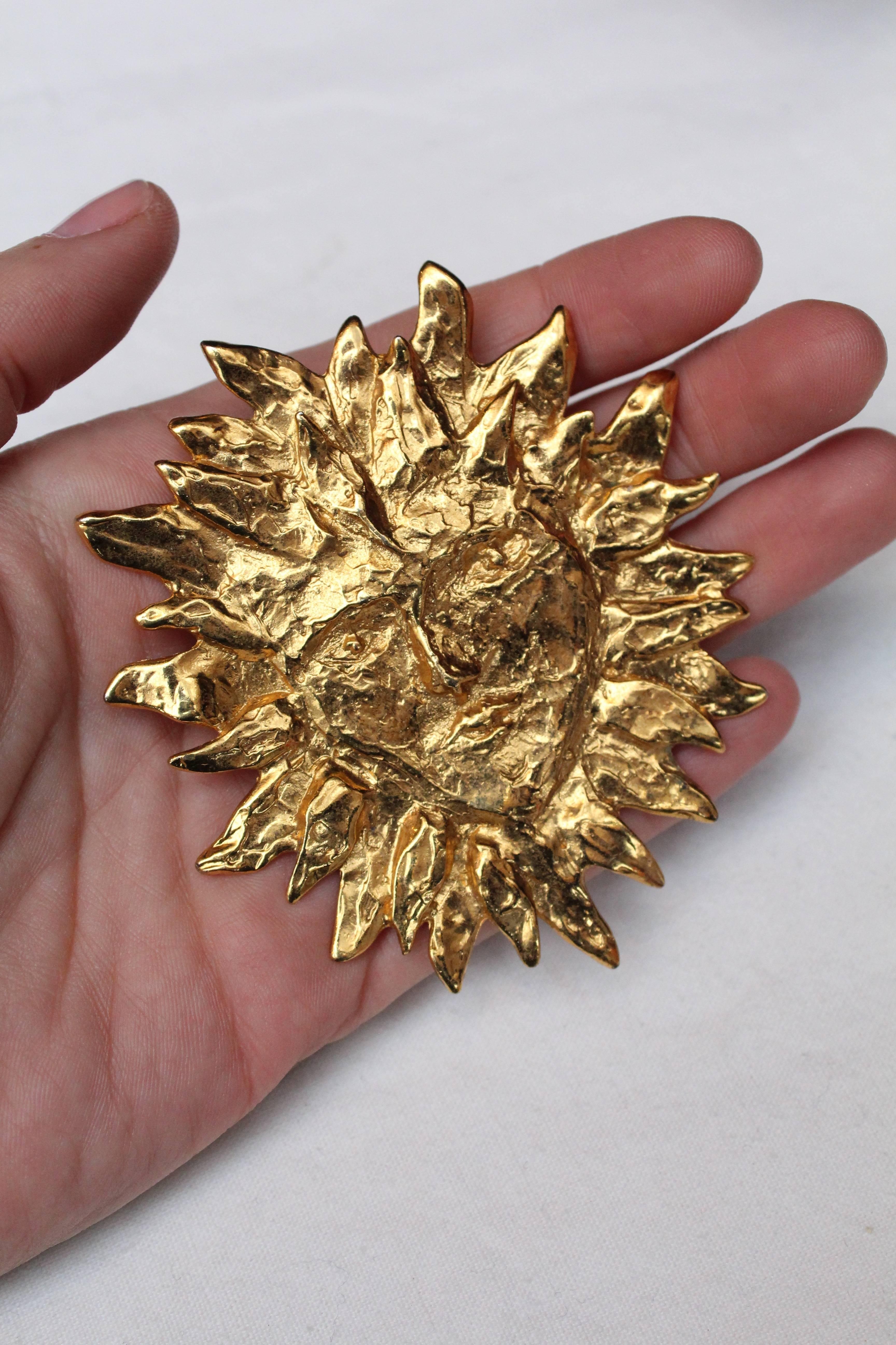 Women's or Men's Yves Saint Laurent gilded metal sun-shaped brooch, 1980s 