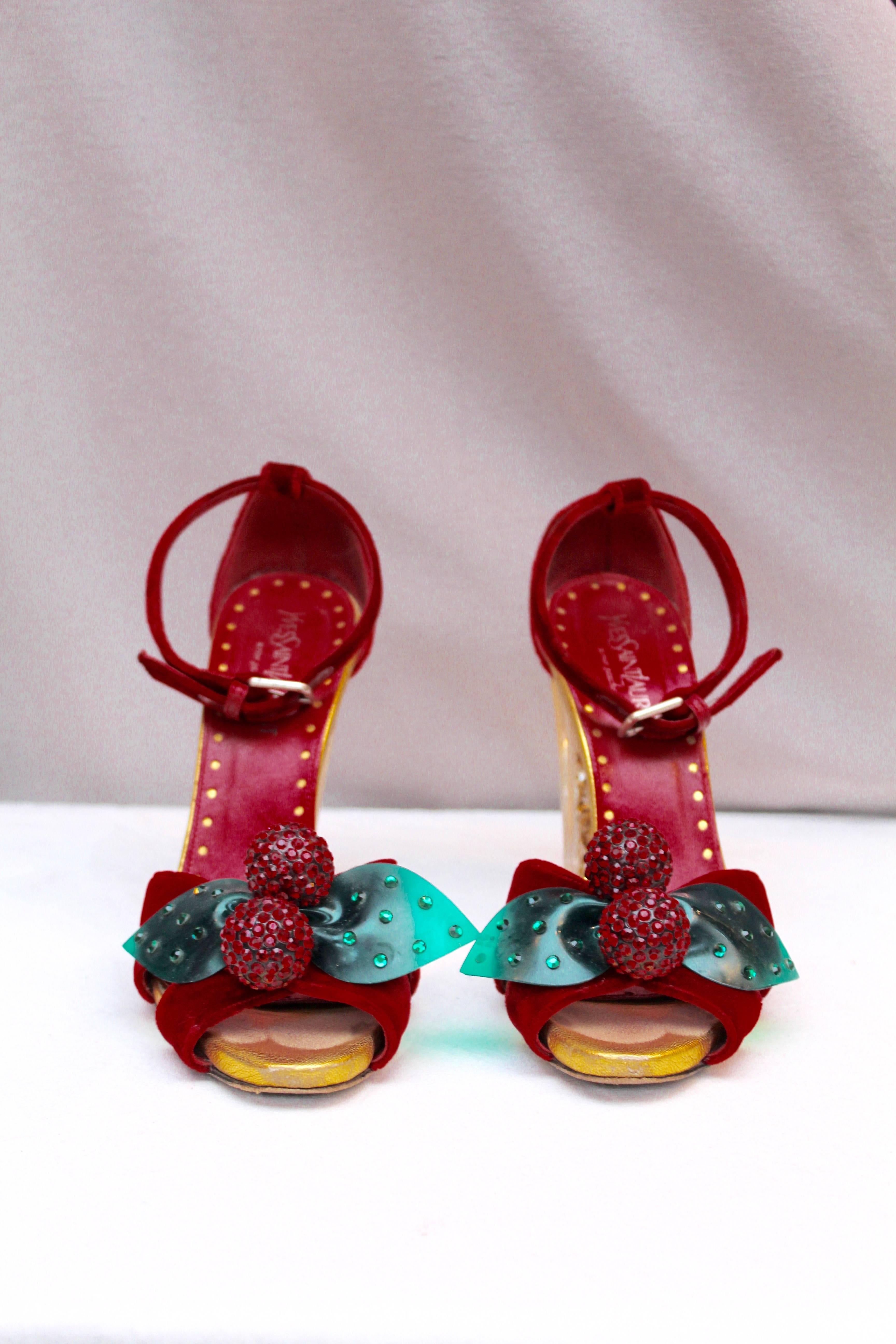 YVES SAINT LAURENT (Made in France) Splendid red velvet evening open toe sling-back pumps. The tips are decorated with two red rhinestones spheres and two green leaves, representing cherries. The heel is made of Lucite and rhinestones.

Size