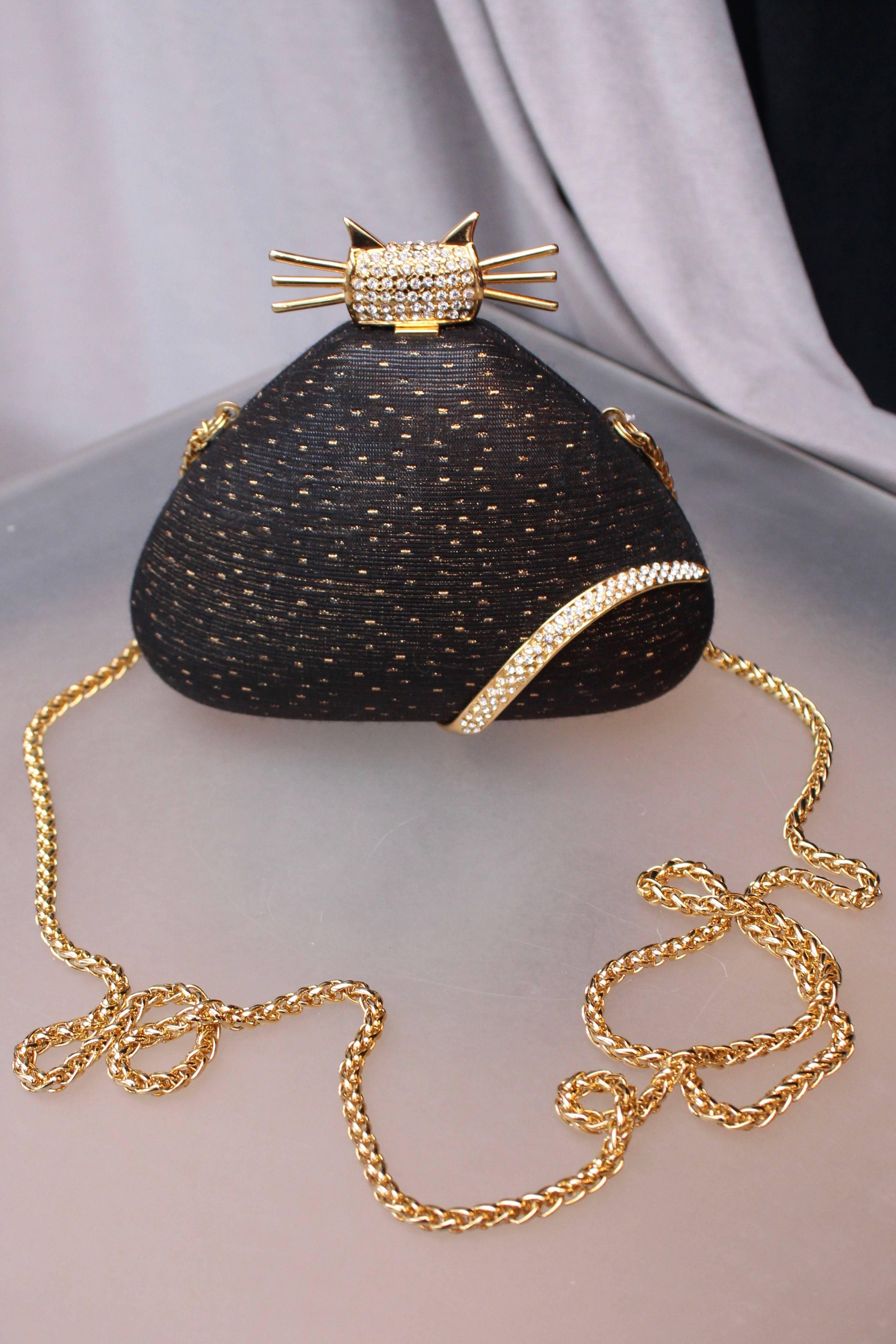 RODO (Made in Italy) Lovely evening triangular”minaudière” composed of black fabric with golden lamé speckle, representing a cat. The tail and the head of the cat are represented by gilded metal elements paved with rhinestones. Black monogrammed