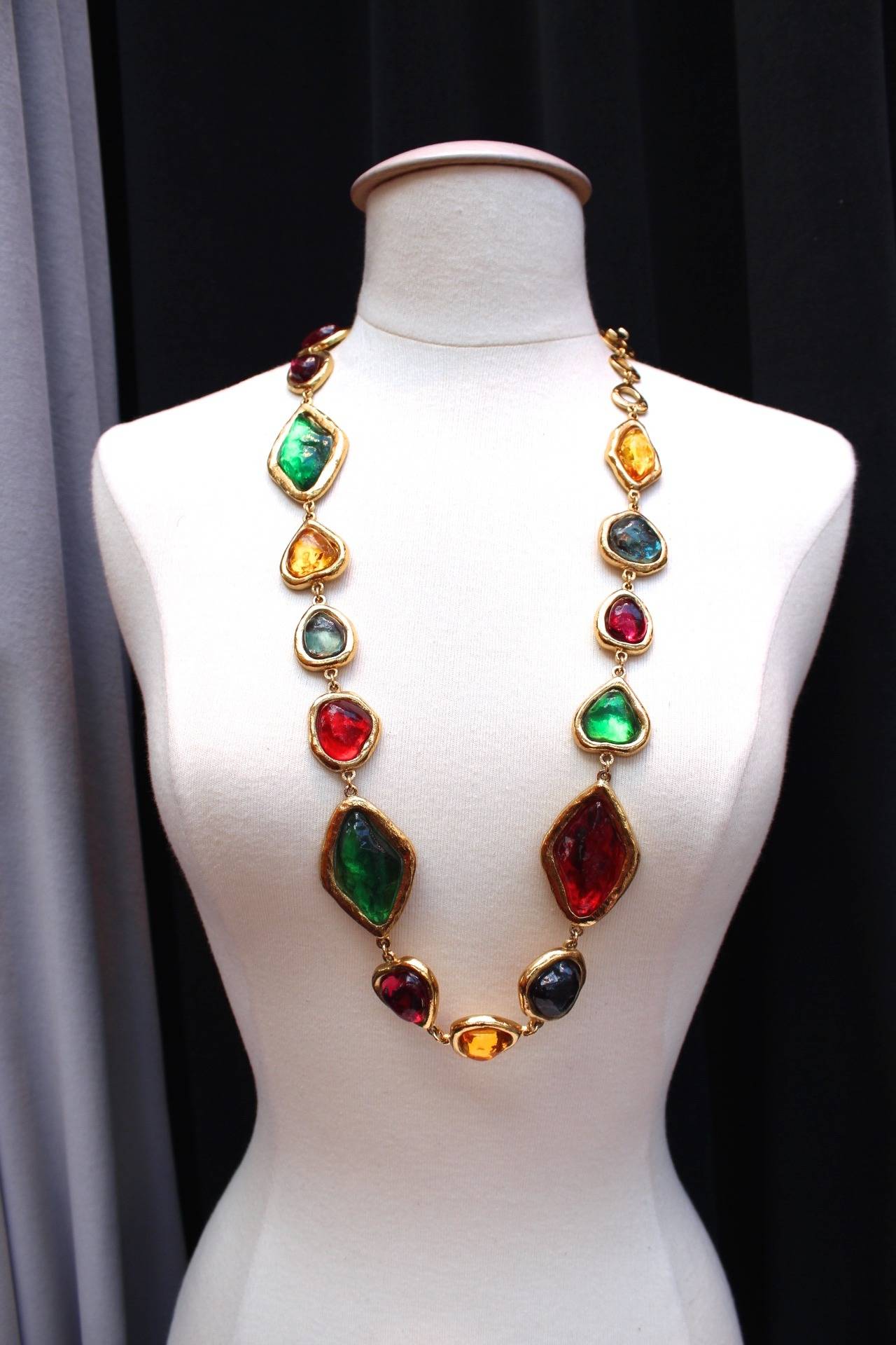 Exceptional Multi-colored necklace of Yves Saint Laurent made by Robert Goossens, circa 1980, composed of a succession of blue, green, yellow, red and orange resin cabochons circled by hammered gold metal. 
Length adjustable thanks to a toggle