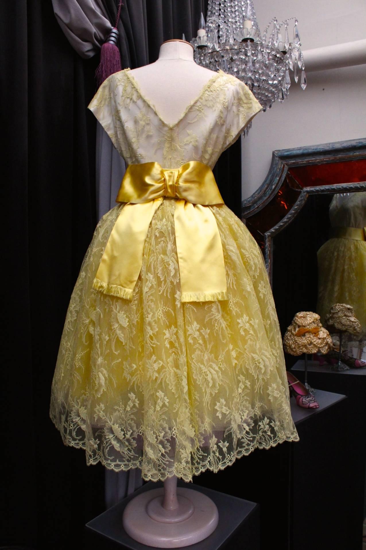JEANNE LANVIN by CASTILLO mid-length evening dress comprising of yellow lace with floral motif on white silk constructed with a V neck top with short sleeves and a voluminous 