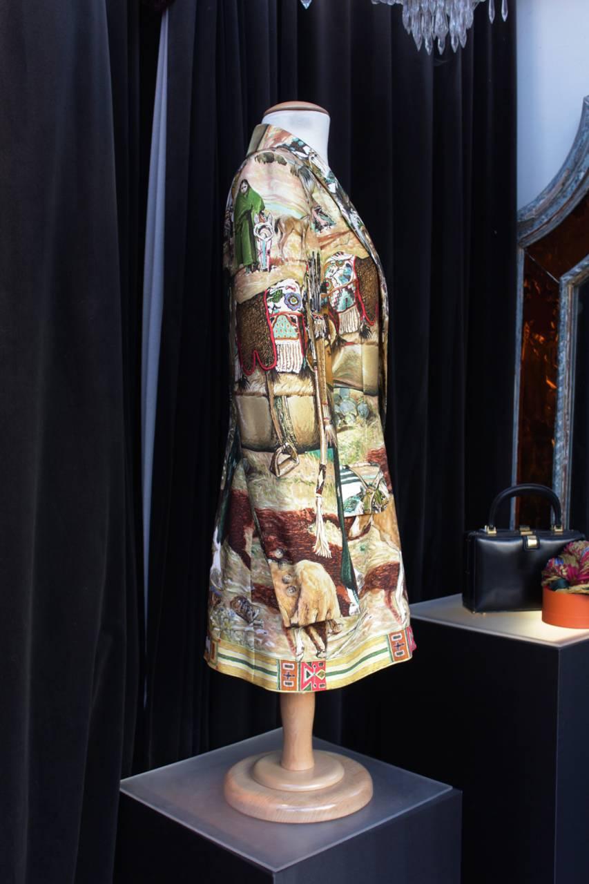 HERMES (Made in France) Rare evening jacket in silk printed with a farwest inspiration including natives americans, their art and crafts, horses and dogs in shades of ocher, green, cream, brown, red and black 

The silk is printed with a pattern