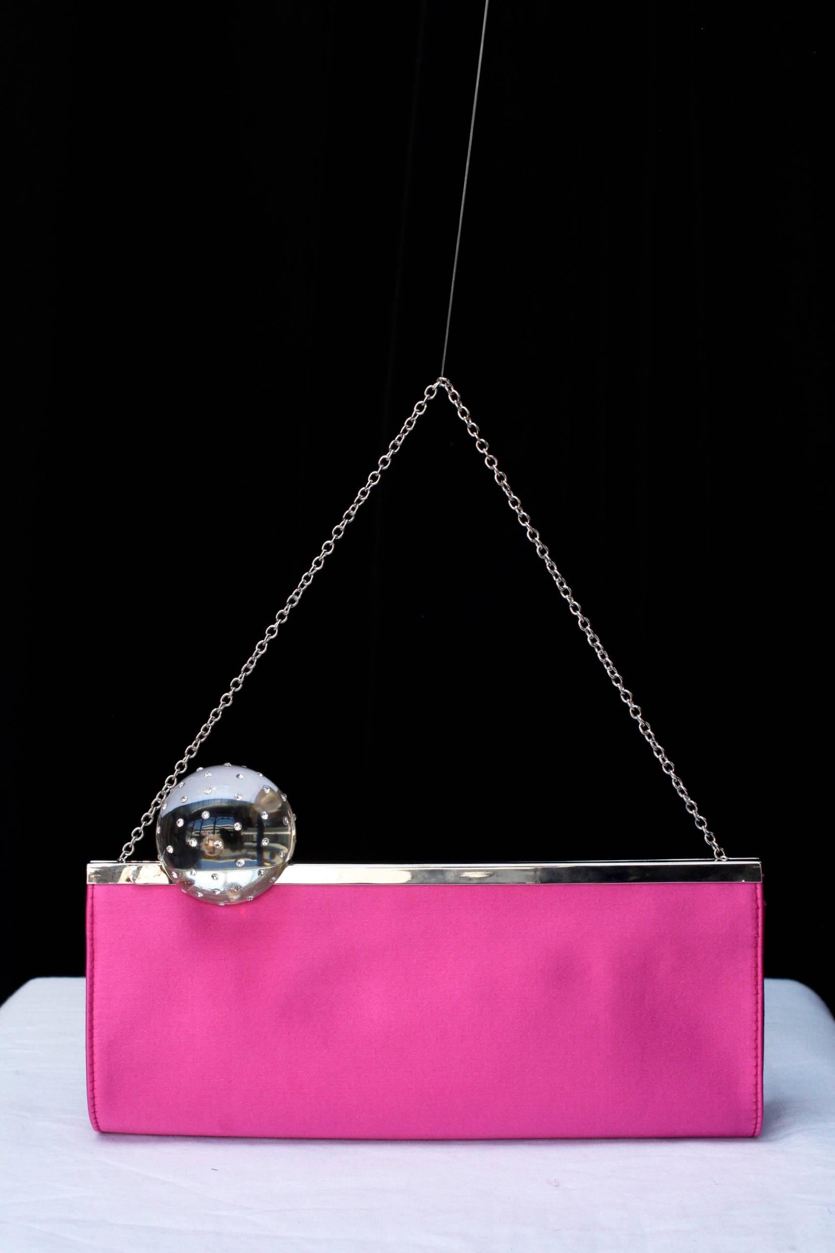 Pink Charles Jourdan evening clutch made of fuchsia satin and transparent sphere