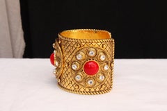 1990s Christian Dior gilded metal cuff with rhinestones and red cabochons