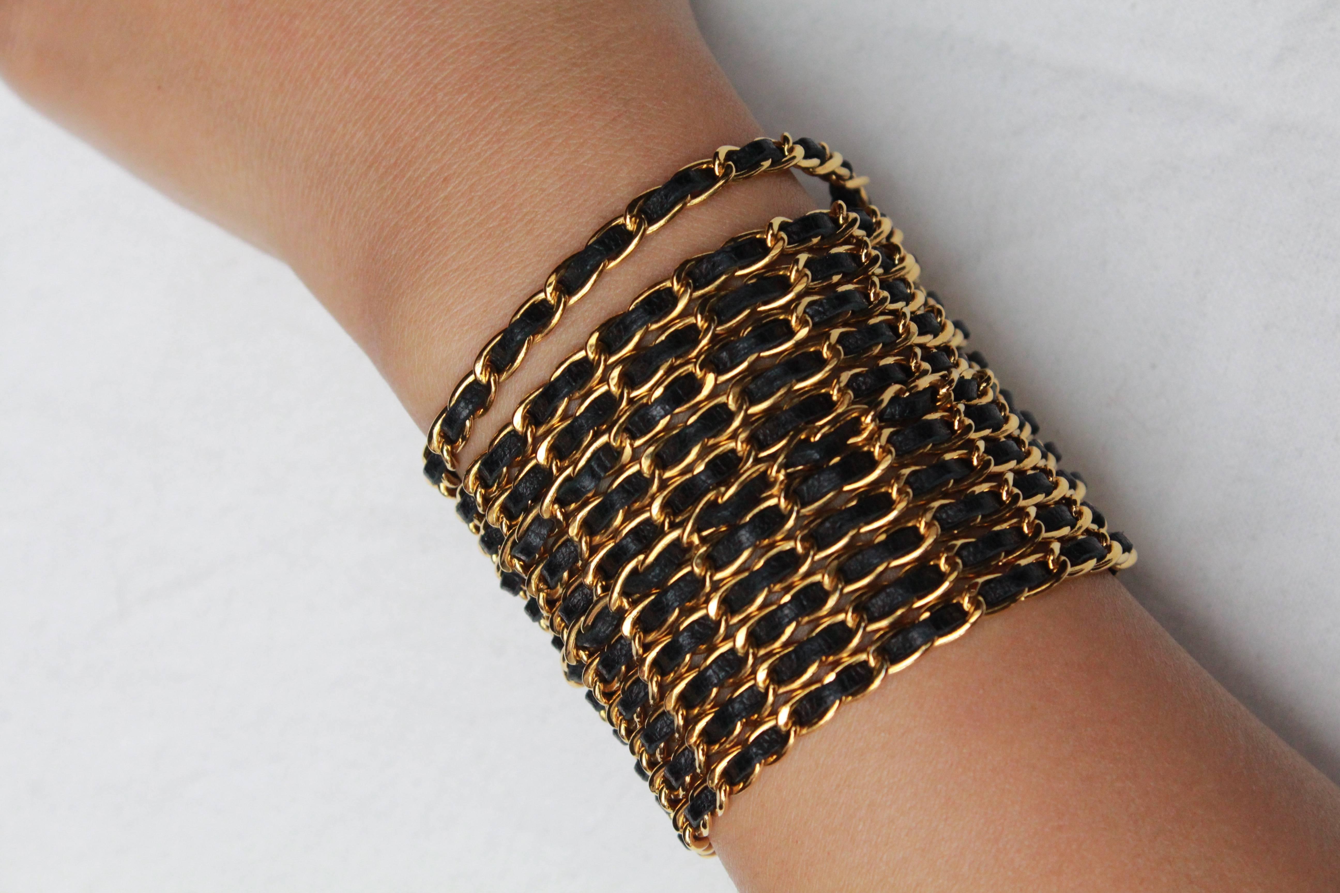 Chanel wide bracelet composed of gilded metal chains with black leather, 1990s  2