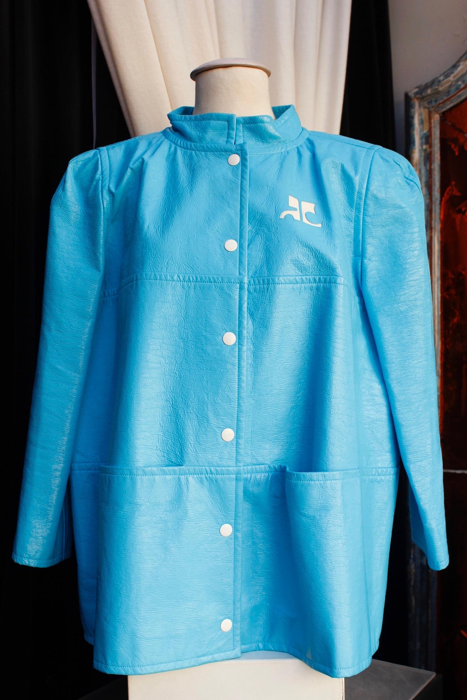 COURREGES (Paris) Iconic jacket composed of light blue vinyle with a series of white snaps,  and two patch pockets. The white brand logo is visible at the bust.

The oversize jacket features a loose cut. Indicated size 36, but fits also a 38 (US