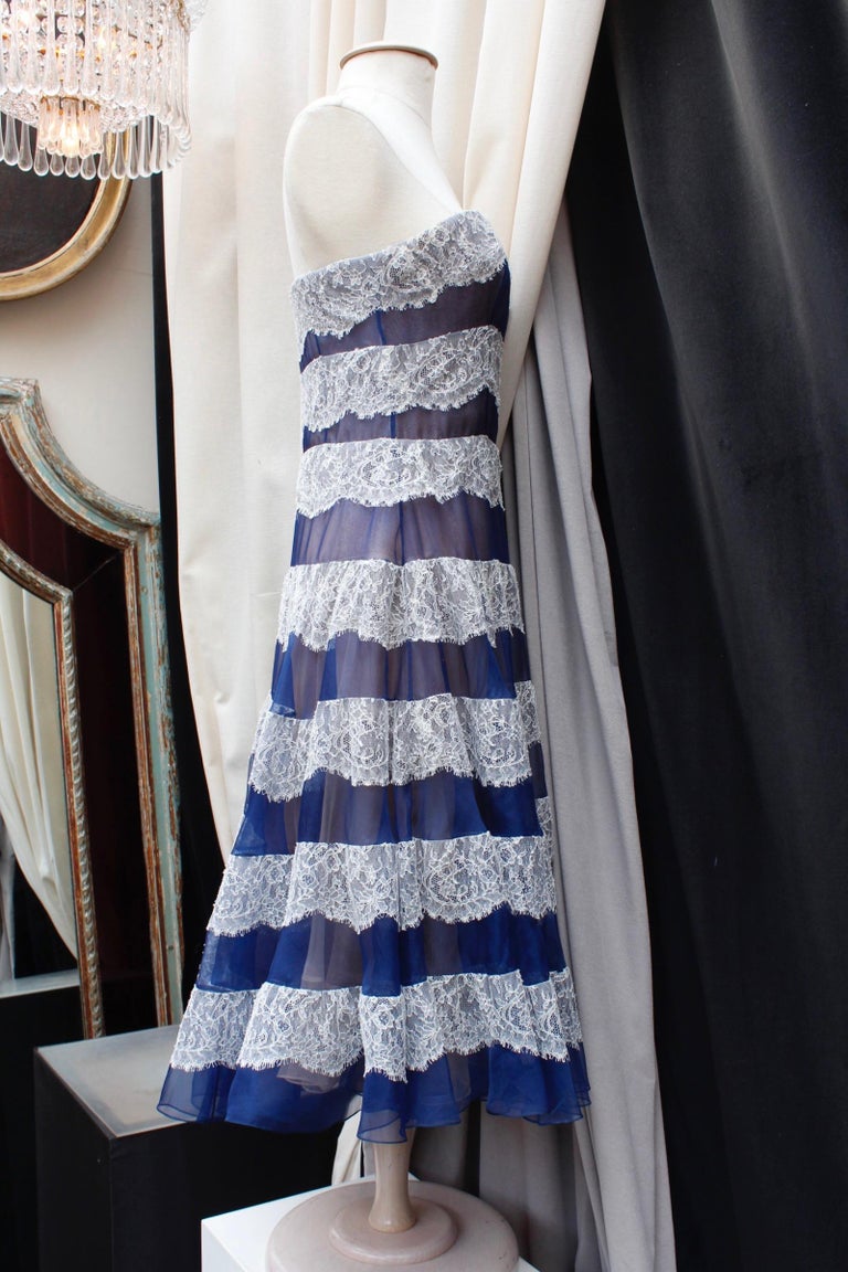 CHRISTIAN DIOR (Made in France) Lovely skater halter dress, composed of a transparent navy blue silk veil decorated with white lace stripes over a nude silk background, in the style of lingerie. The upper part features a corset for a better support.