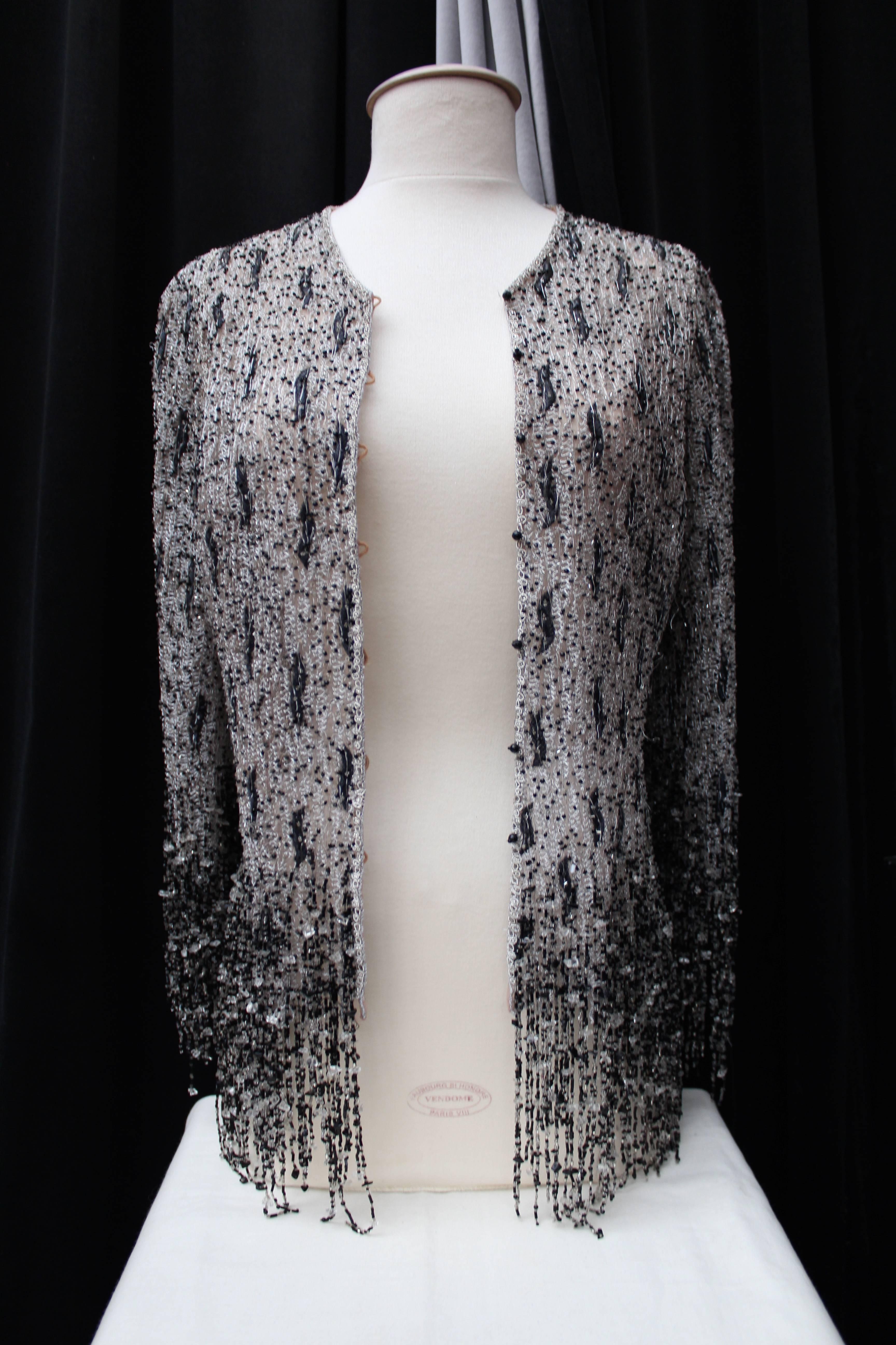 LECOANET HEMANT (Paris) Evening vest jacket with long sleeves made of tulle fully embroidered with silver thread and transparent and black beads as well as black thread sewed in a vegetable pattern. The jacket is finished at the armhole and bottom