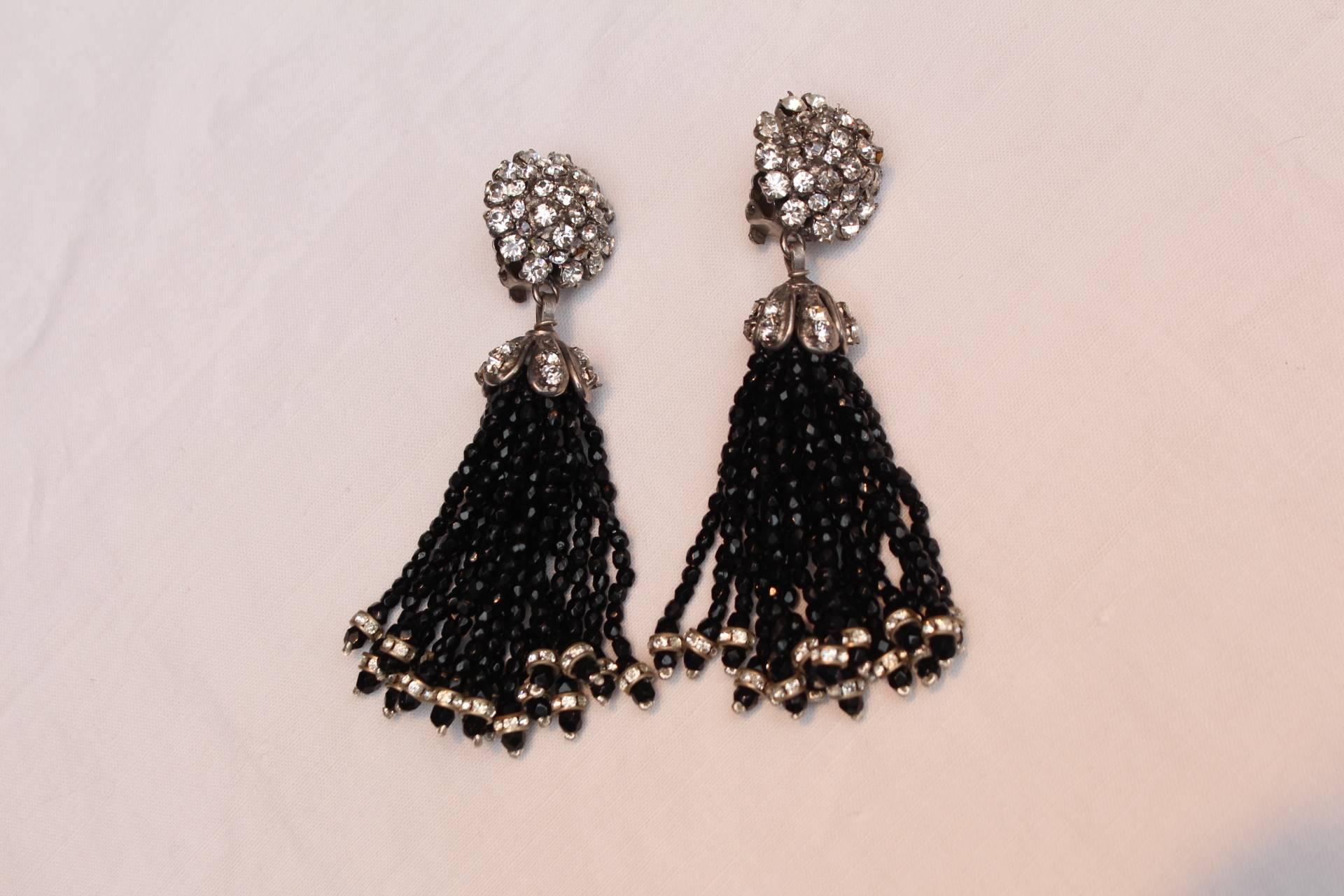 CHANEL (Made in France) Collection Fall 1995 - Gorgeous drop clip on earrings comprised of a silver metal demi sphere paved with white crystals holding a tassel composed of multi strands of black beads finished with white crystals. 

These