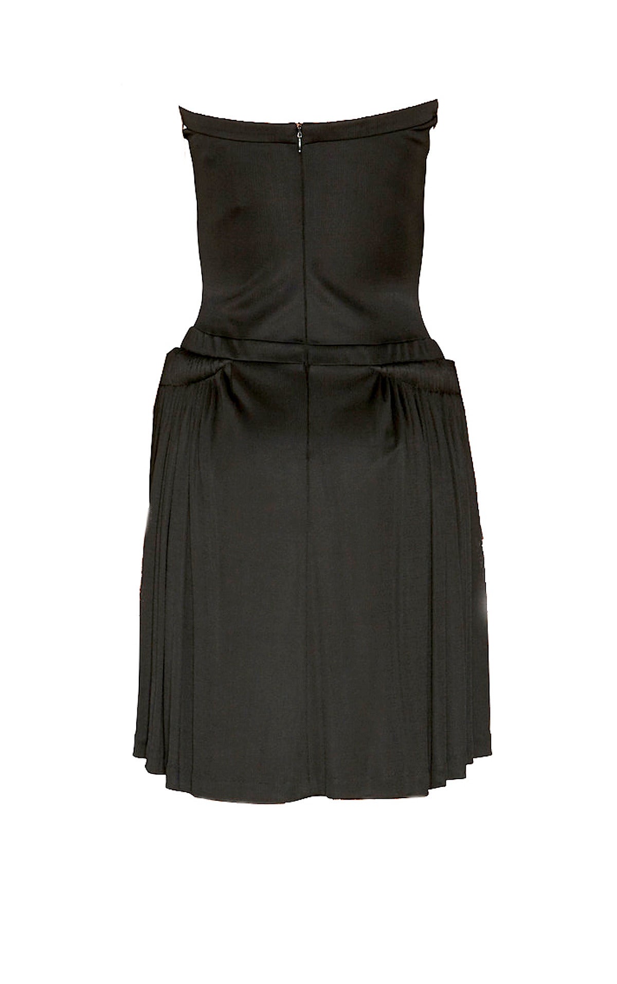 Stunning Balenciaga 2008 black viscose strapless knee-length dress with bustier and intricate folds along each hip, creating gorgeous draping at the bottom of the dress.
Back zippered closure.