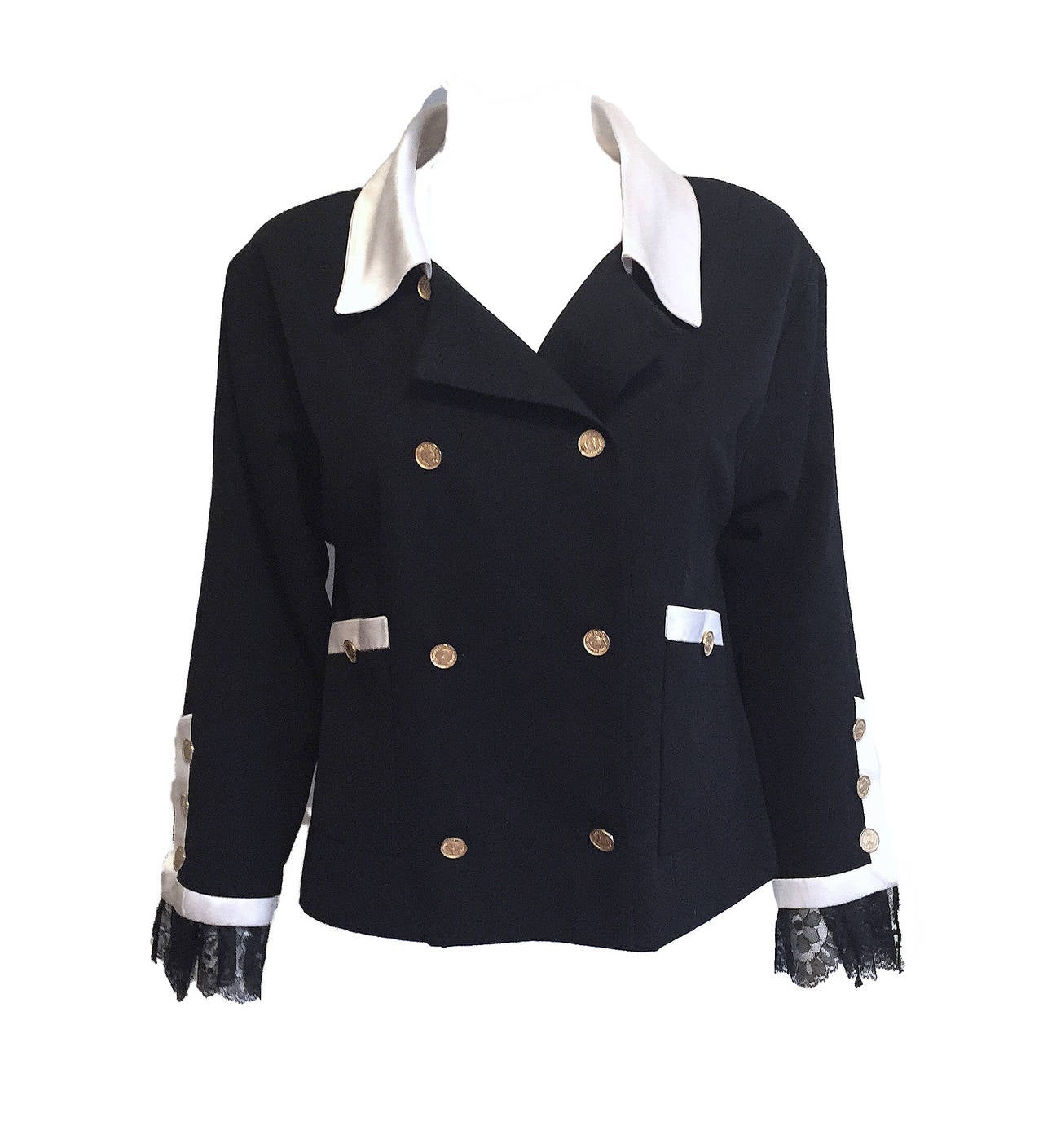 This Chanel jacket was reportedly modeled by Inès de la Fressange in the early 1980s, just a few years after the House launched its Ready to Wear line in 1978. Black wool with ivory silk collar and accents, gold-tone buttons, and lace-trimmed