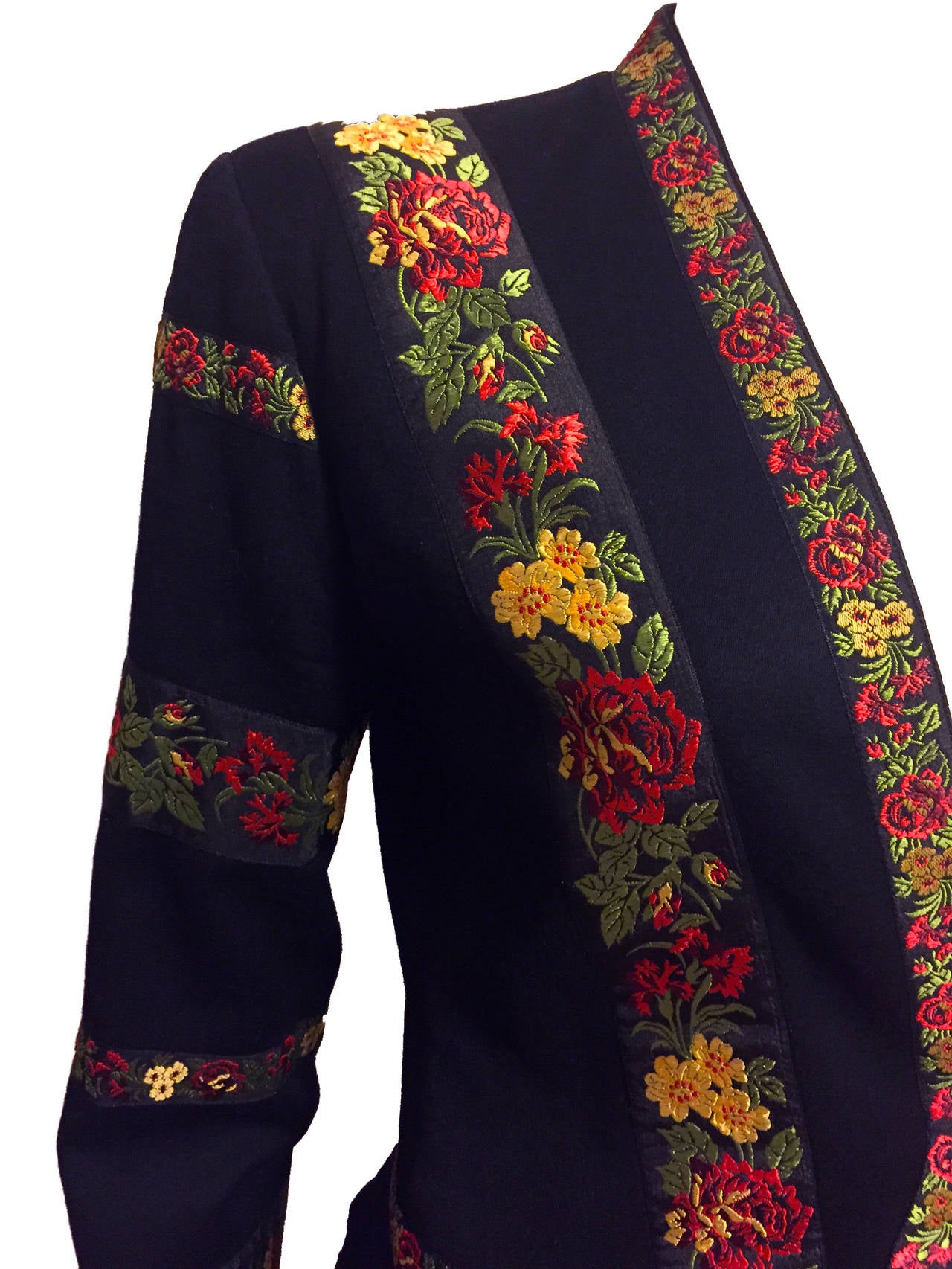Beautiful vintage Kenzo skirt suit featuring a folkloric boho theme, with a black wool jacket with intricate floral embroidery and accompanying black lace skirt with lining from the 1970s. Jacket features single front button closure. Skirt has a