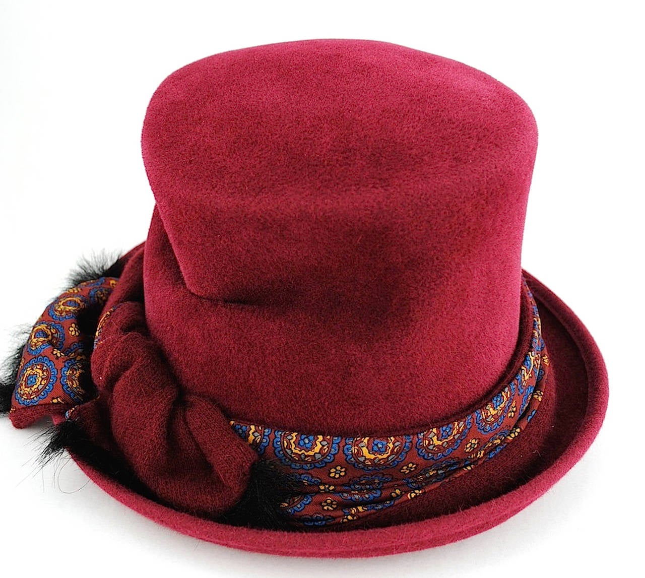 Stephen Jones ‘Jones Boy’ maroon felt hat. It features a short turned up rim, a scarf tied in a knot around the rim, a pinched design on the right side of the hat and black lining with a repeated print of the Stephen Jones