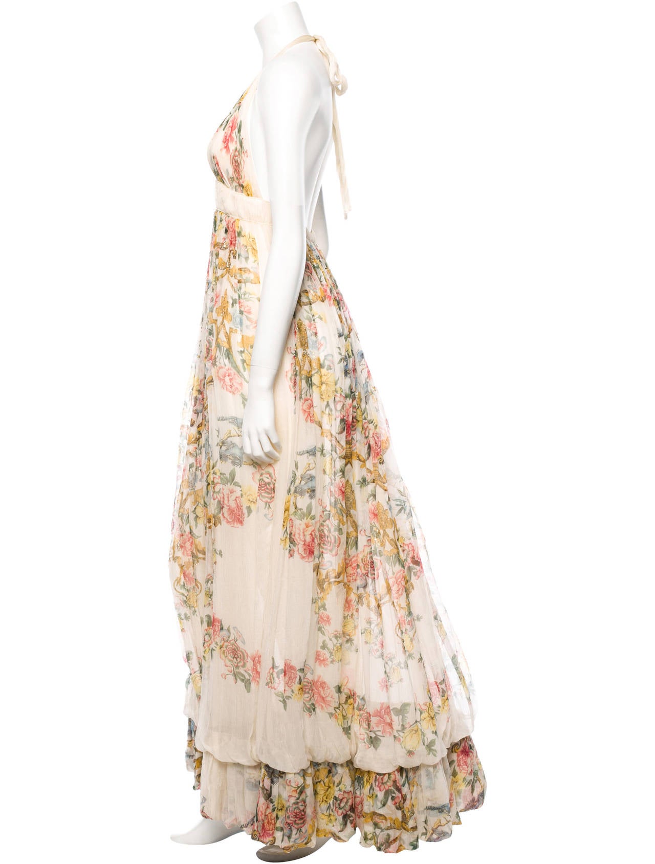 Roberto Cavalli elegantly draped ivory silk gown with floral print throughout, metallic accents, two-layer skirt, halter tie, and invisible back zip closure.

Measurements: Bust 28”, Waist 28”, Length 60”