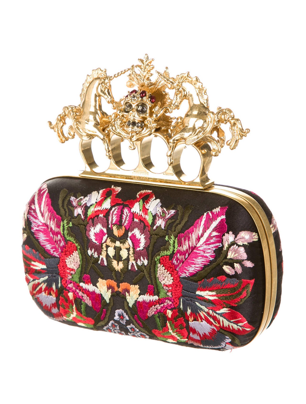Very rare Alexander McQueen black satin knuckle box clutch with embroidered print throughout, gold-tone frame and hardware, black leather lining, and top gold-tone knuckle clasp closure featuring unicorn and skull embellishments. It is from the
