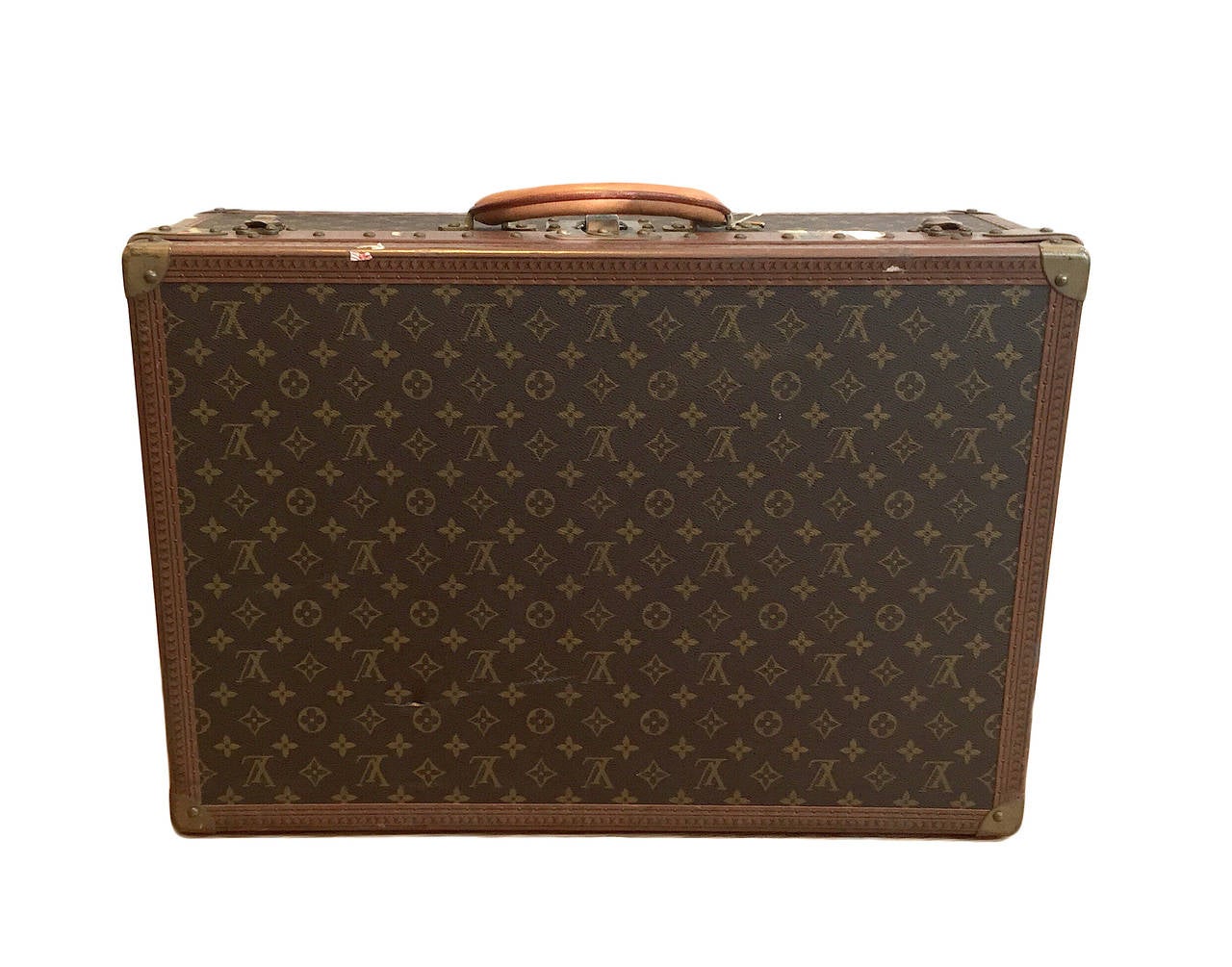 Louis Vuitton vintage Alzer 60 hardsided travel trunk featuring exterior monogram canvas, eather trim reinforced with rivets, golden brass corners, brass hardware, rounded leather handle, canvas lining, removable wood tray, and a pair of keys for