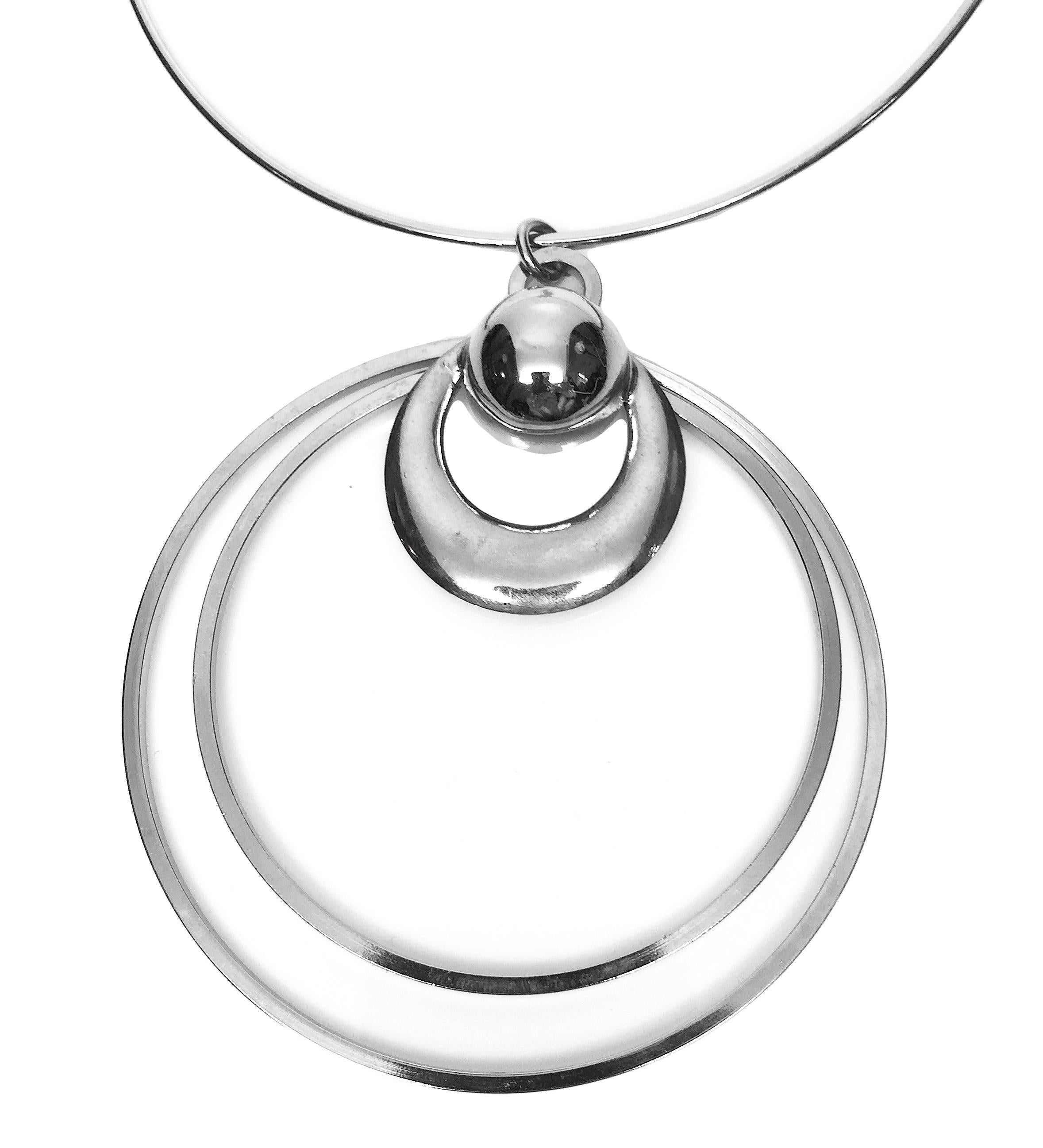 Pierre Cardin attributed unsigned prototype necklace circa 1975. The necklace consists of a metal choker with hook closure, and a large metal pendant with concentric circles. Unsigned but confirmed Pierre Cardin prototype. 

Diameter 16