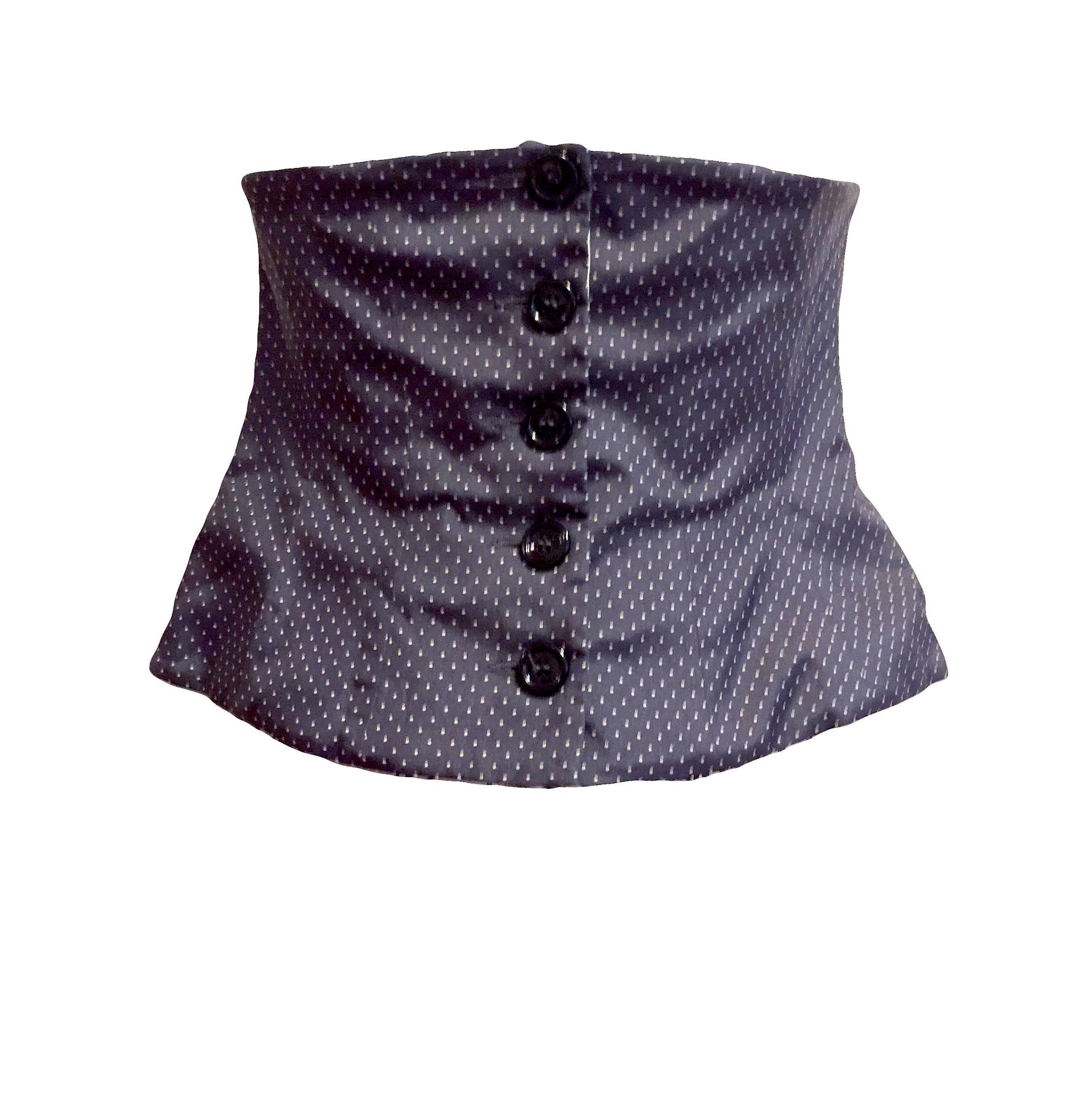 Yves Saint Laurent navy and ivory polka dotted strapless bustier top with front button closure and a ruffle accent in the back.
Measurements: Bust 29