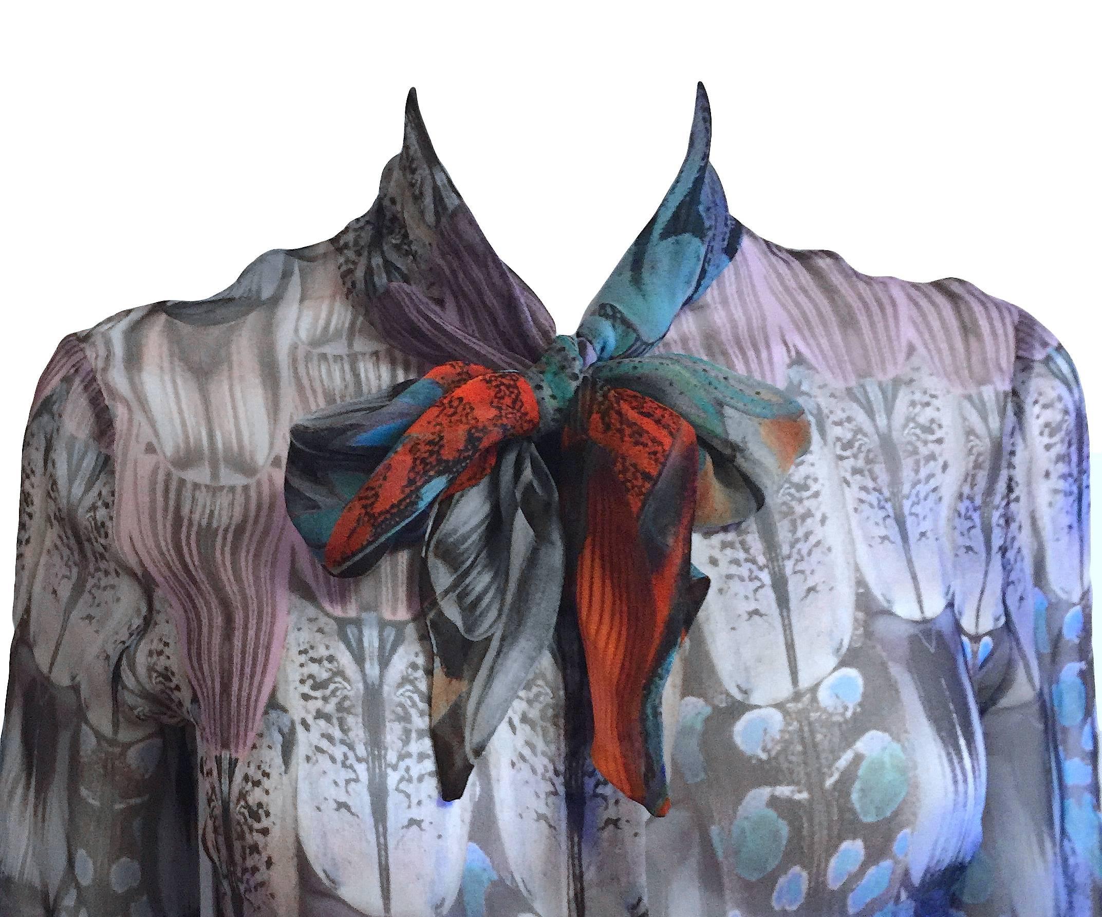 Rare Alexander McQueen sheer silk blouse in an abstract multi-color print with hidden front button closure, bow tie at neck, and long ties at end of sleeves. From his SS 2008 Collection 