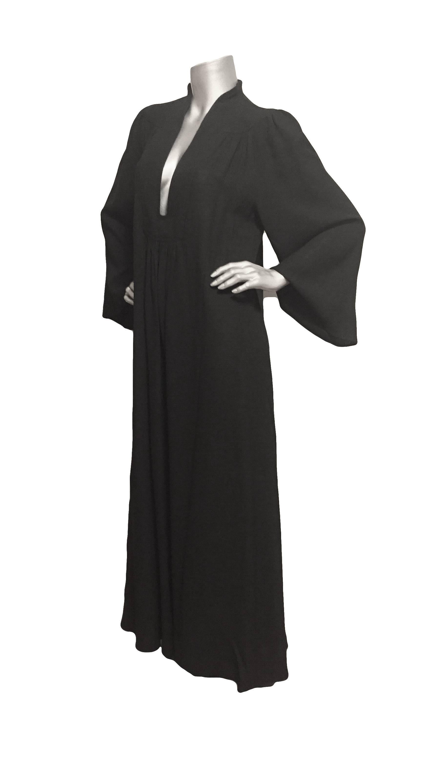 Fabulous Ossie Clark loose fitting black crepe moss dress with long sleeves and a plunging neckline from the 1970s, Studio 54 style.