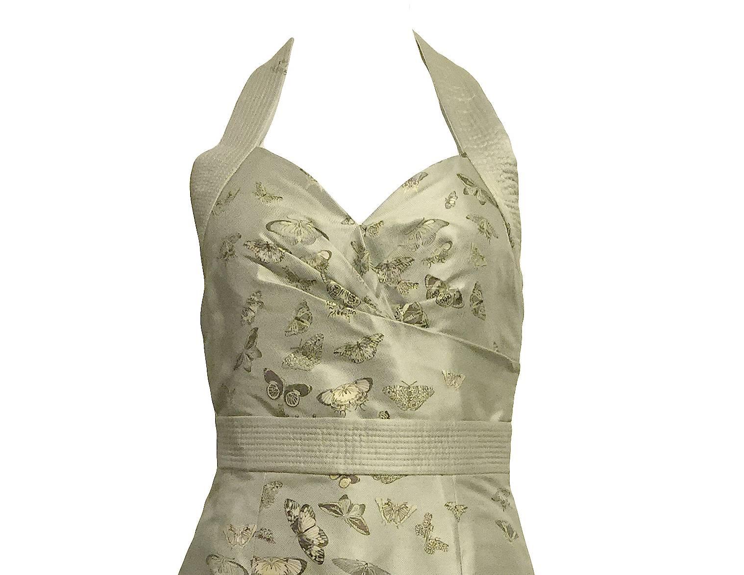 This stunning Alexander McQueen light green silk halter dress is embellished with hand-painted butterflies throughout. It has a side zipper closure and closer at the back of the halter neck. 

Bust 28”, Waist 32”, Hip 34”, Length 37”