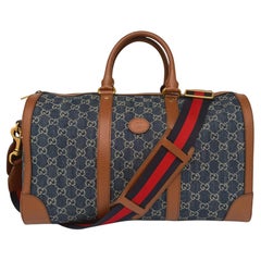 Gucci Denim GG Supreme Canvas and Brown Leather Duffle Bag, Spring/Summer 2022.