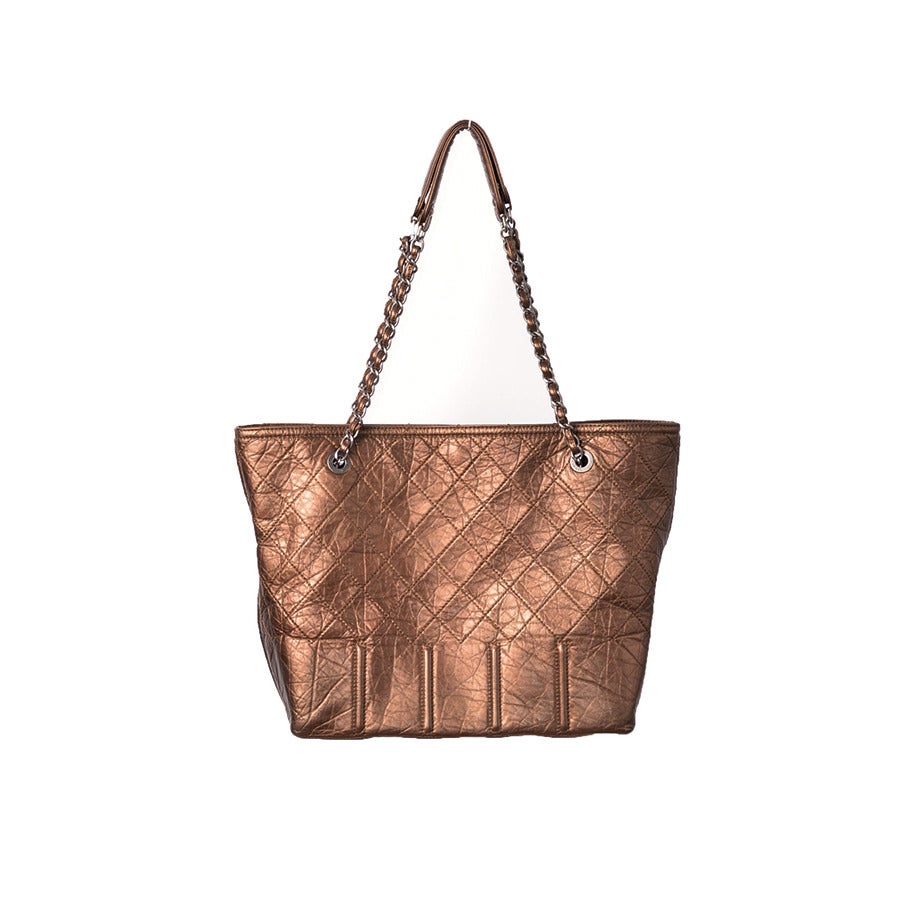 This contemporary interpretation of the popular CHANEL shopping bag in distressed leather, is a beautiful & unique addition to any wardrobe..for any woman.Signature diamond quilting with large tone on tone CC logo front.
Double shoulder straps: