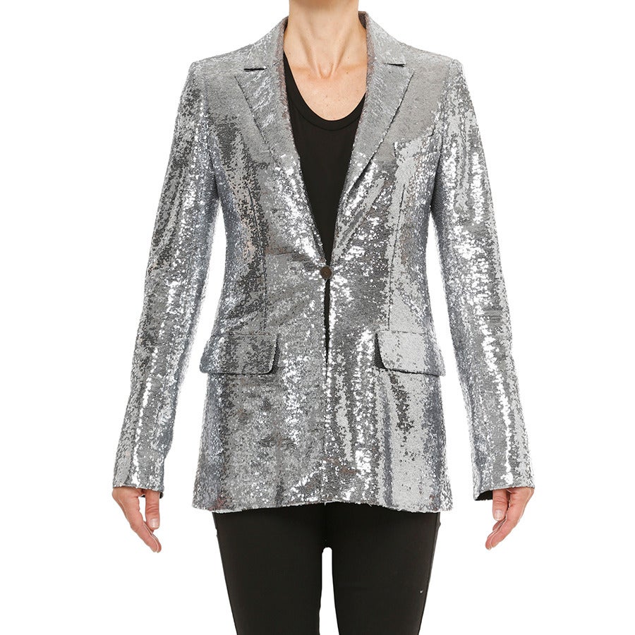 Chanel's “Rock & Roll” blazer with all-over sequins  is the epitome of  “Glitz & Glam”!  
- 1 button front closure with CHANEL Paris motif
- Matching lining in 100% silk with exclusive CC logo and camellia motif
- Size 38 regular fit
- Black