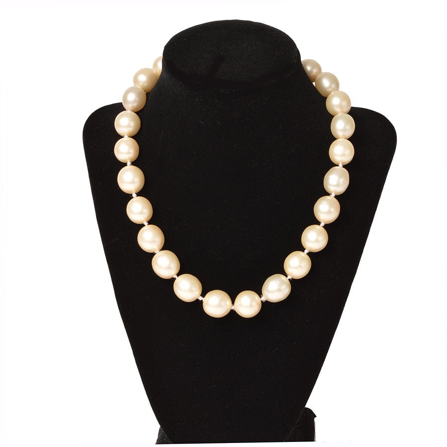 A stunning Chanel pearl chocker necklace with gold tone metal especially elegant on a long swan-like neck.   
- Hand shaped faux glass pearls
- Hook closure with dangling mini pearl & single Swarovski crystal  on  2