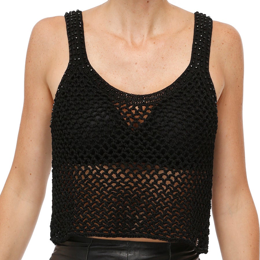This beautiful sleeveless Chanel top has been hand crocheted in ribbon cord.  The double row finishing around the neck & armholes are each embroidered with a rows of  tiny multifaceted black beads: almost 450! A tiny black rectangular plaque with