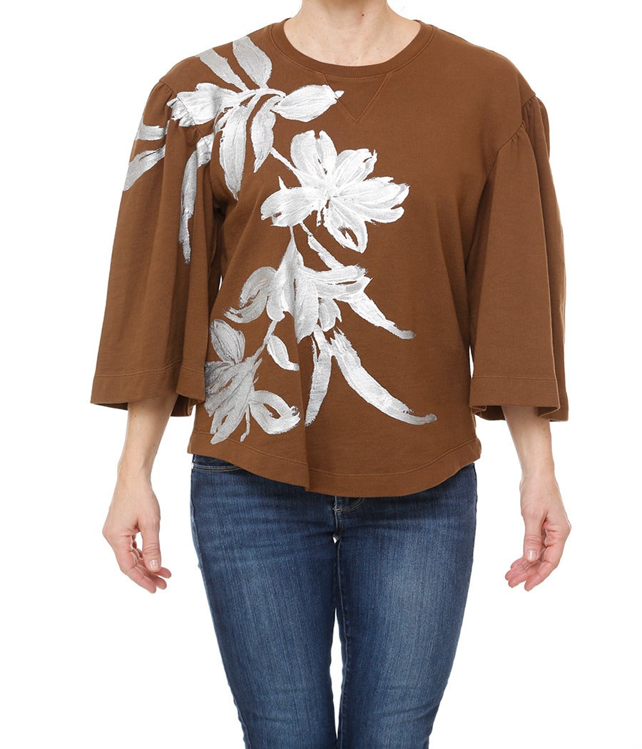 Dries Van Noten hand-painted sweatshirt in brown with silver painted design.
- Three quarter length sleeves
- Gathered shoulder detail 
- Hand-painted front panel may vary slightly 
- Size: Small
- Condition: like new, worn once
-