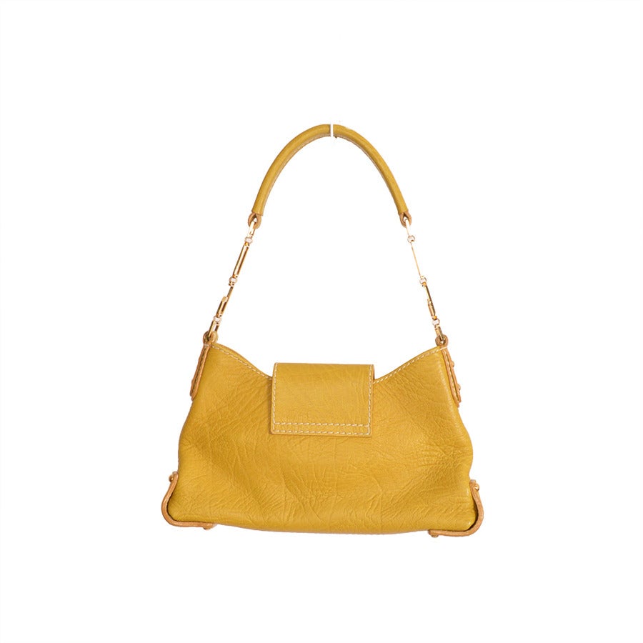 Dolce & Gabbana small yellow handbag with gold hardware and white stitching detail.
- 