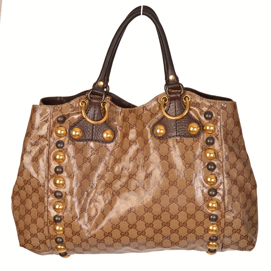 Gucci babouska crystal coated canvas medium tote in beige. Gold tone and oxidized brass hardware, brown leather and suede trim
- Two rolled handles, front tassels
- Canvas plaid interior with leather trim, 2 interior pockets
- Measurements: