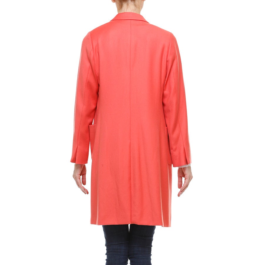This beautiful 100% cashmere lightweight coral coloured coat by Jill Sander is the perfect pop of colour for spring! Tailored fit, fully lined in matching coloured silk. Two front open pockets.
- Single inside button on each cuff 
- Notched