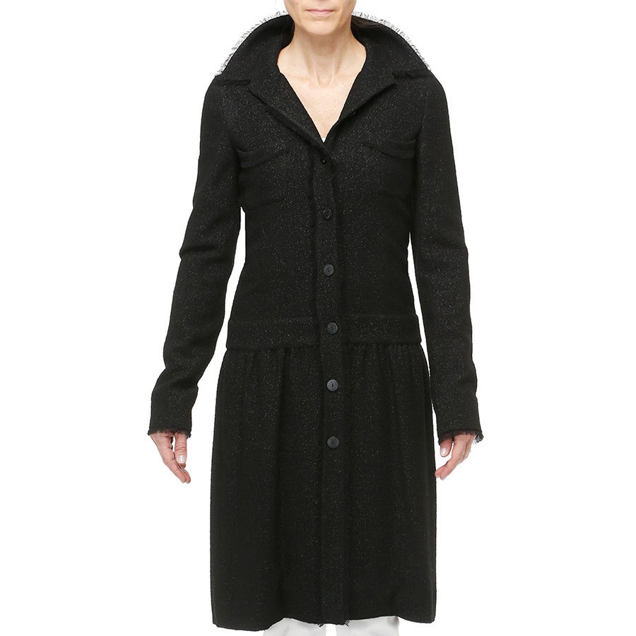 A flexible silhouette combining a fitted torso with an ever so slightly gathered feminine skirt, this unique CHANEL piece can worn closed as a dress or open as a long jacket or coat.

- Fringe trim
- 2 skirt pockets
- 8 round black matte buttons