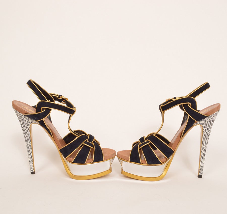 New YSL, Yves Saint Laurent navy suede sandals with gold-tone piping, silver tone platforms and printed stiletto heels. 
- Size: 37
- Made in Italy
- Comes with shoe bag
- Condition: New, one light mark on left front from being in box
-
