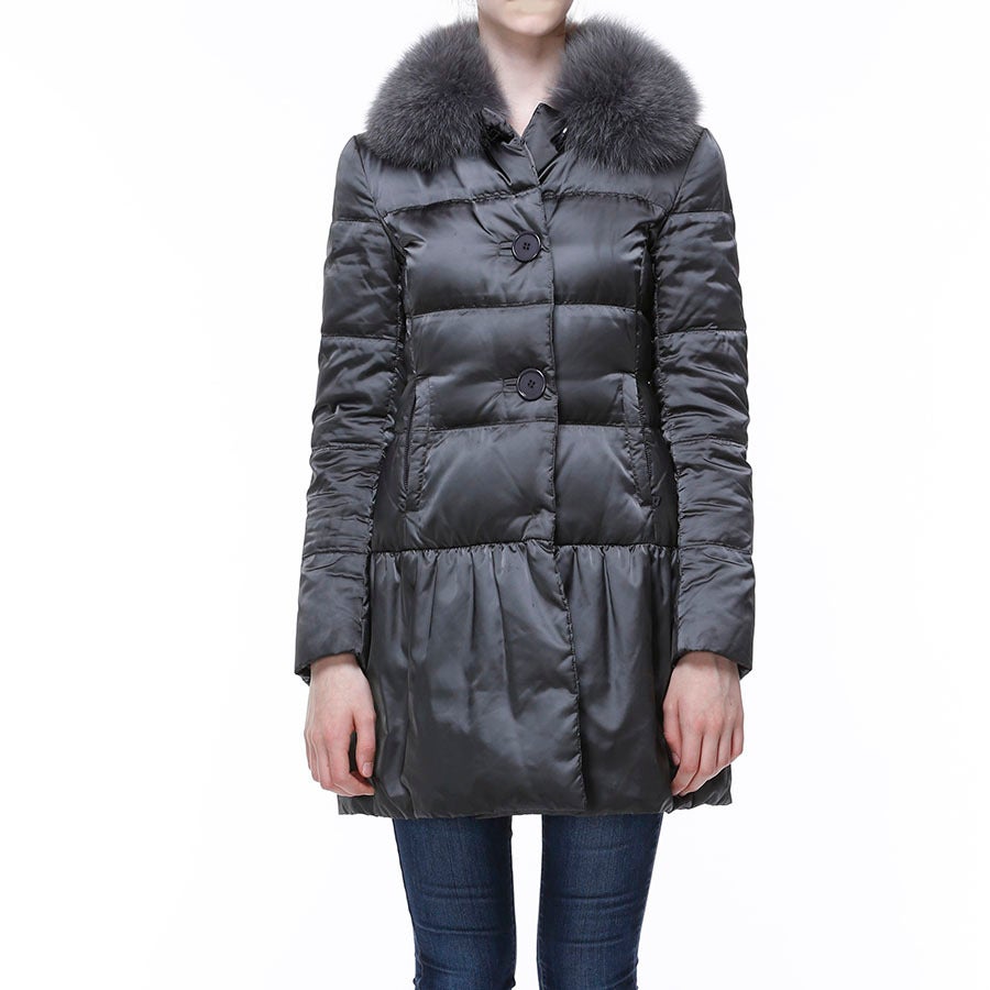 Prada grey puffer coat with fur collar. Beautiful Prada grey puffer coat with fox fur collar. Features button up coat that is slightly gather towards the bottom and has to zipper pockets. 
- Prada grey puffer coat 
- Fox fur collar 
- Gathering