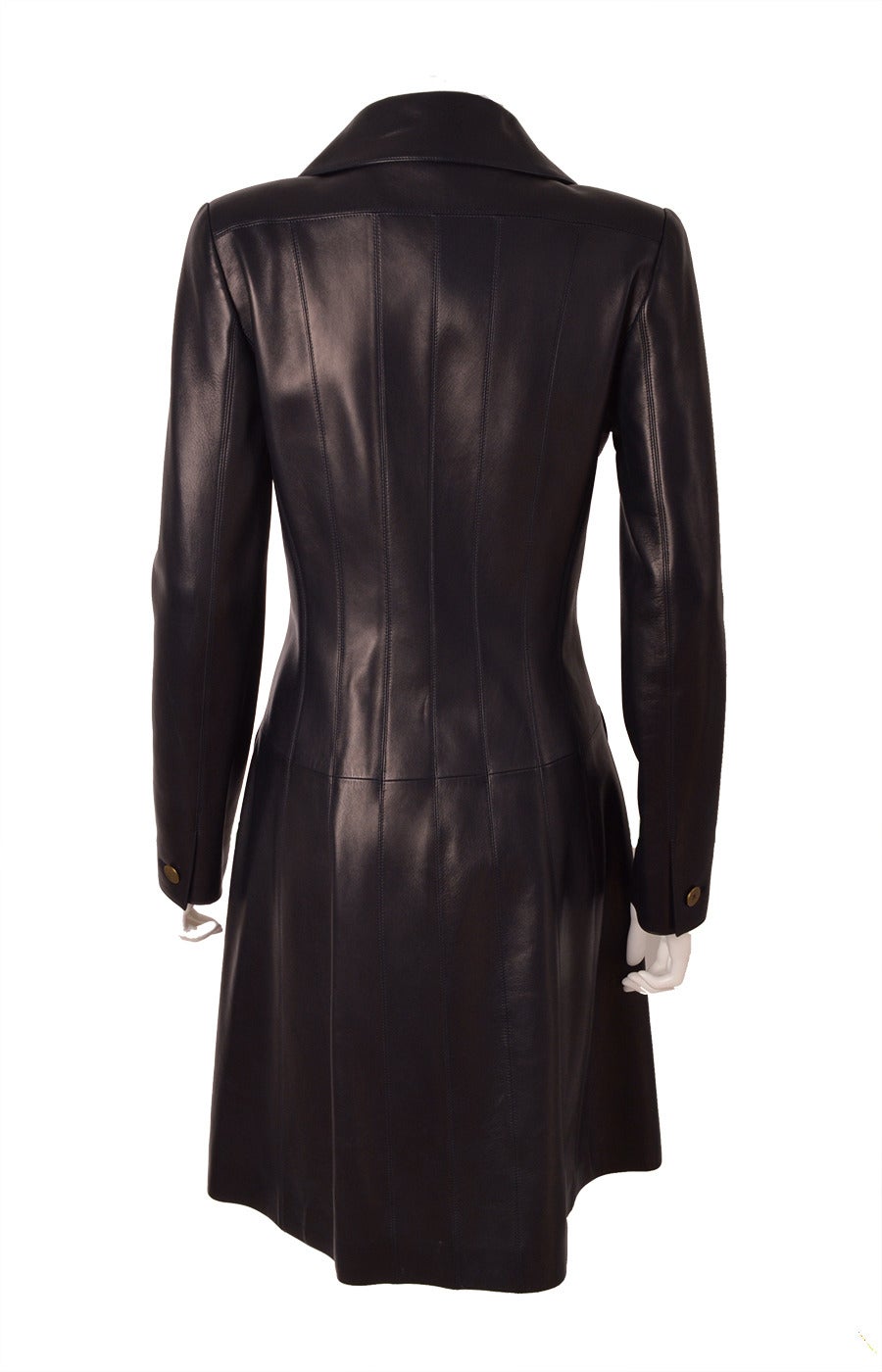 An exquisite Chanel double breasted lambskin leather knee length coat. This  beautiful silhouette features a notched lapel and four pockets: two front flap and two small flap breast pockets. Two panels sewn horizontally and seven seams at the back.