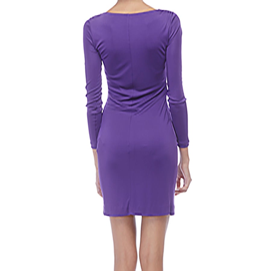 Purple Emilio Pucci cocktail dress with long sleeves, bateau neckline, cutout at bust, gathering at waist with gold-tone logo plaque and side invisible zip closure.

- Condition: Like new, no signs of wear
- Size 4
- Measurements: Bust 32”,