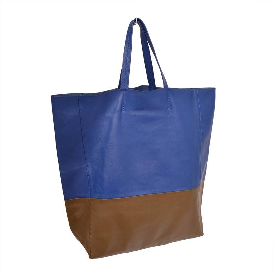 The Celine Bi-Cabas Tote features Royal Blue lambskin leather with a Khaki leather base. The bag has a spacious interior and a single zip pocket makes this bag ideal for travel or all day use. 

- Includes dust bag
- Date/Authentication Code:
-