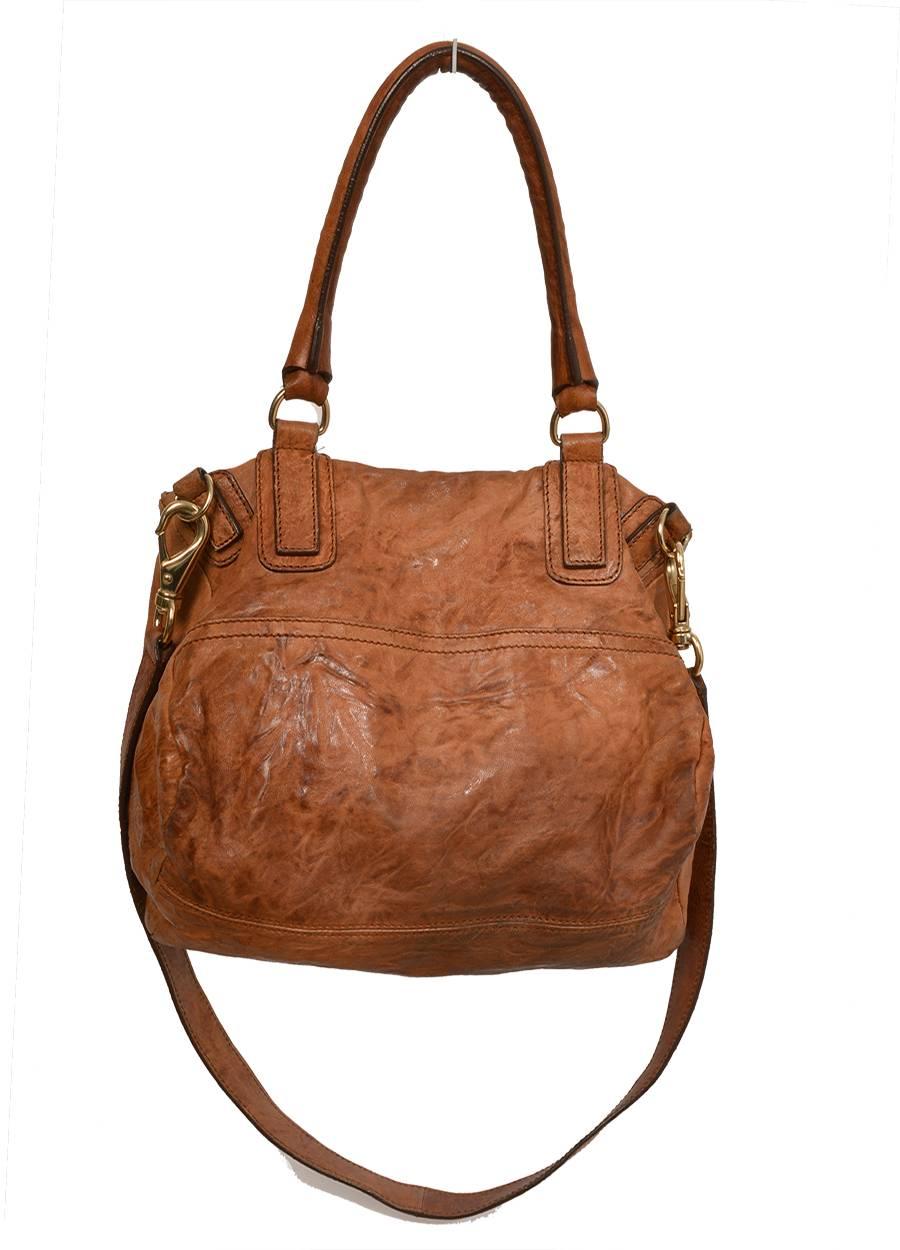 Brown crinkled leather Givenchy Pandora bag with gold-tone hardware, logo at top, rolled handle, removable shoulder strap, dual compartments, three interior pockets and top zip closures. An angled, two-zipper top gives it a one-of-a-kind silhouette.