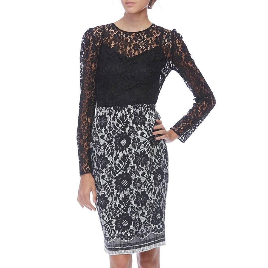 Beautiful Dolce&Gabbana cocktail dress. Black lace long sleeved top with black/white floral patterned silk skirt. Back zip closure. 

- Approx Retail Price: $ 1200.00
- Size: 6 (US)
- Black lace long sleeved top with black/white floral patterned